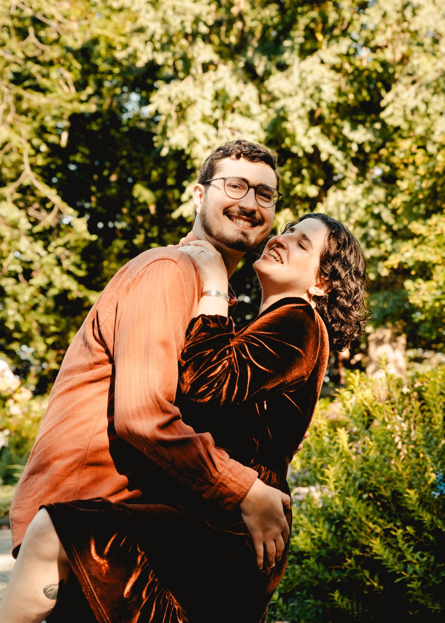 A couple posing for engagement photos in Fort Tryon Park