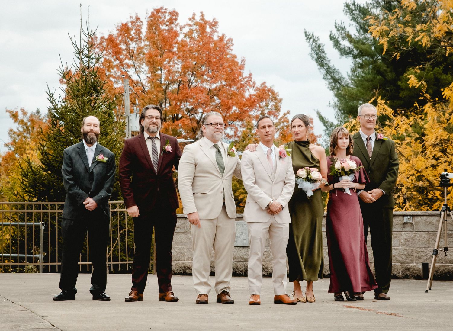 The groom, surrounded by his groomsmen and family, gets emotional as he sees his bride in her dress for the first time.