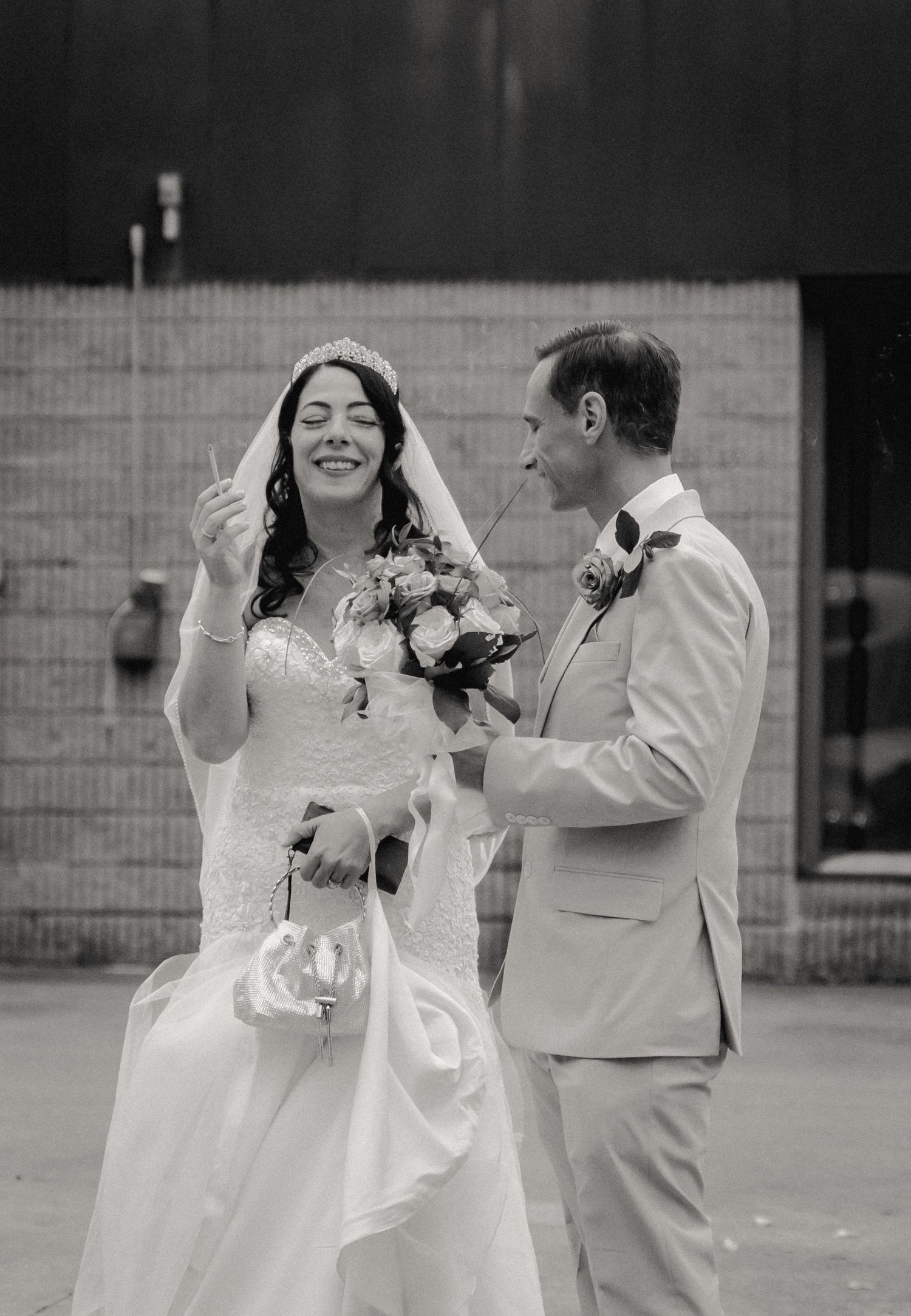 The bride and groom have a private moment to share a drink during the break between their church ceremony and reception in Vestal, NY.