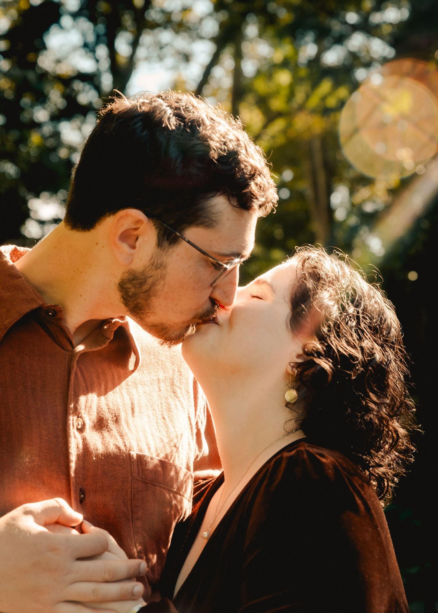 A romantic kiss in Fort Tryon Park in New York City during an engagement photoshoot