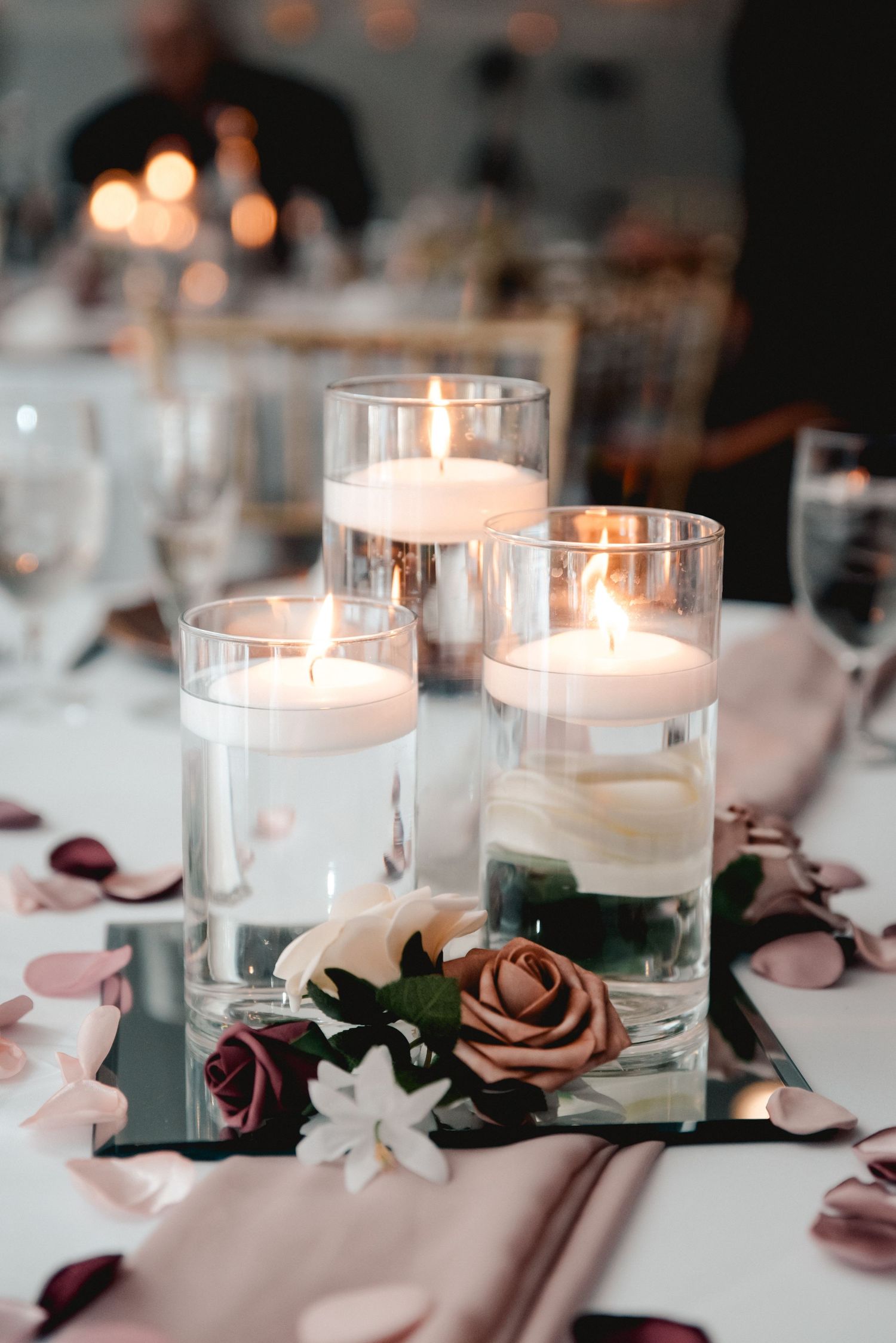 The centerpieces for the guest tables at the Riverdale in Endicott, NY consisted of three candles surrounded by pink roses.