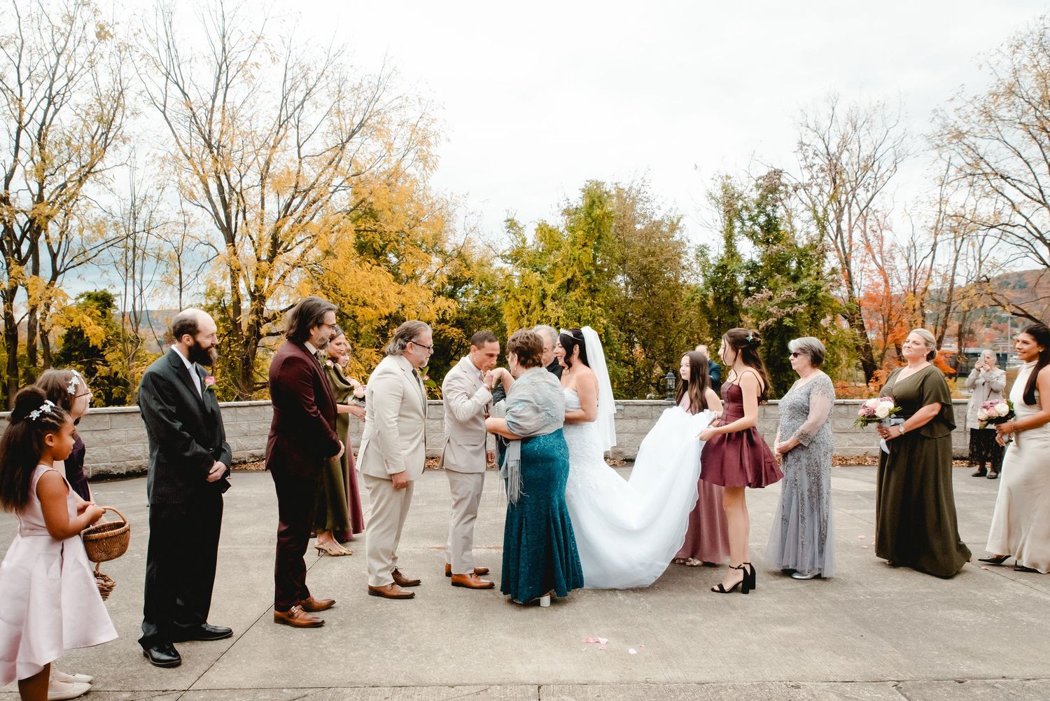 The bride and groom's first look moment before the ceremony, surrounded by their loved ones on a gorgeous fall day in Upstate NY.