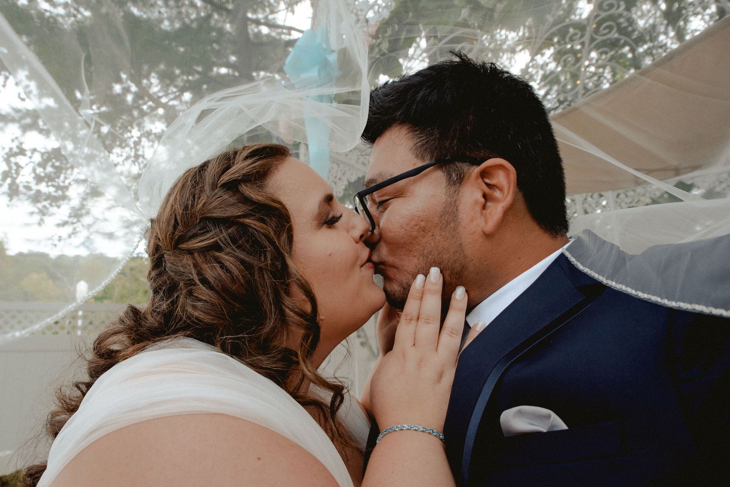 The bride and groom kiss after their private first-look moment before their ceremony in Westchester, NY.