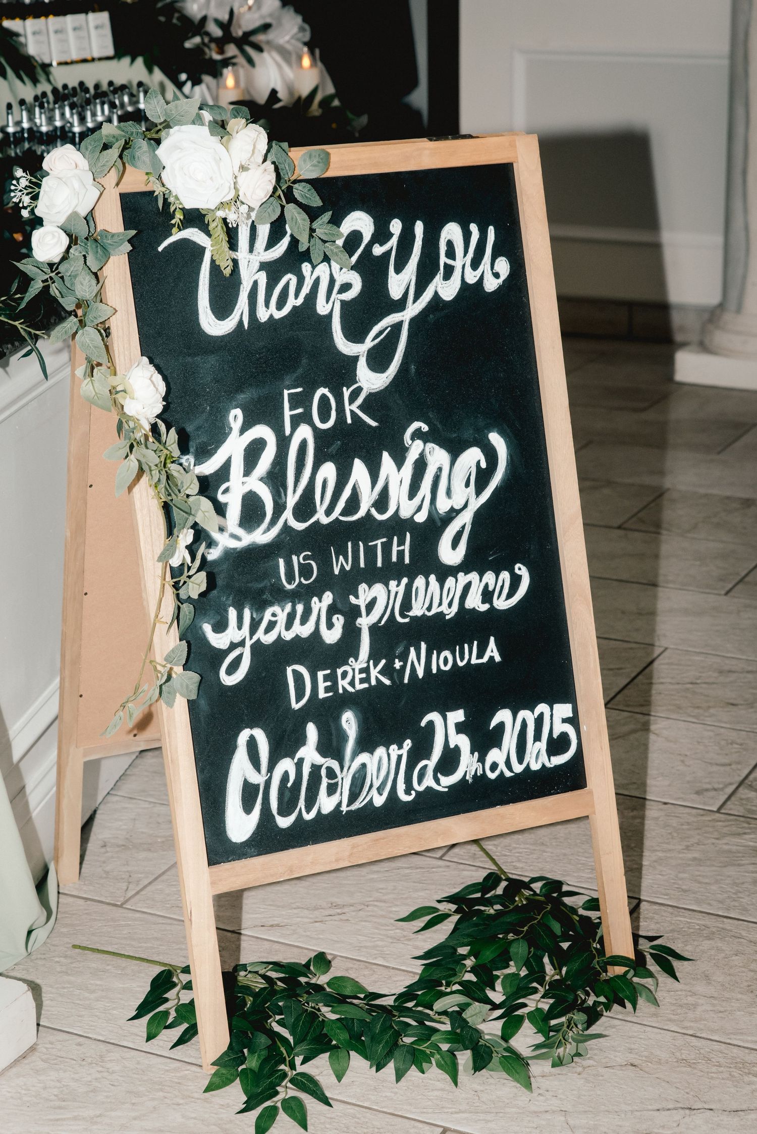 A welcome sign surrounded by flowers welcomes guests to a wedding at The Riverdale in Endicott, NY.
