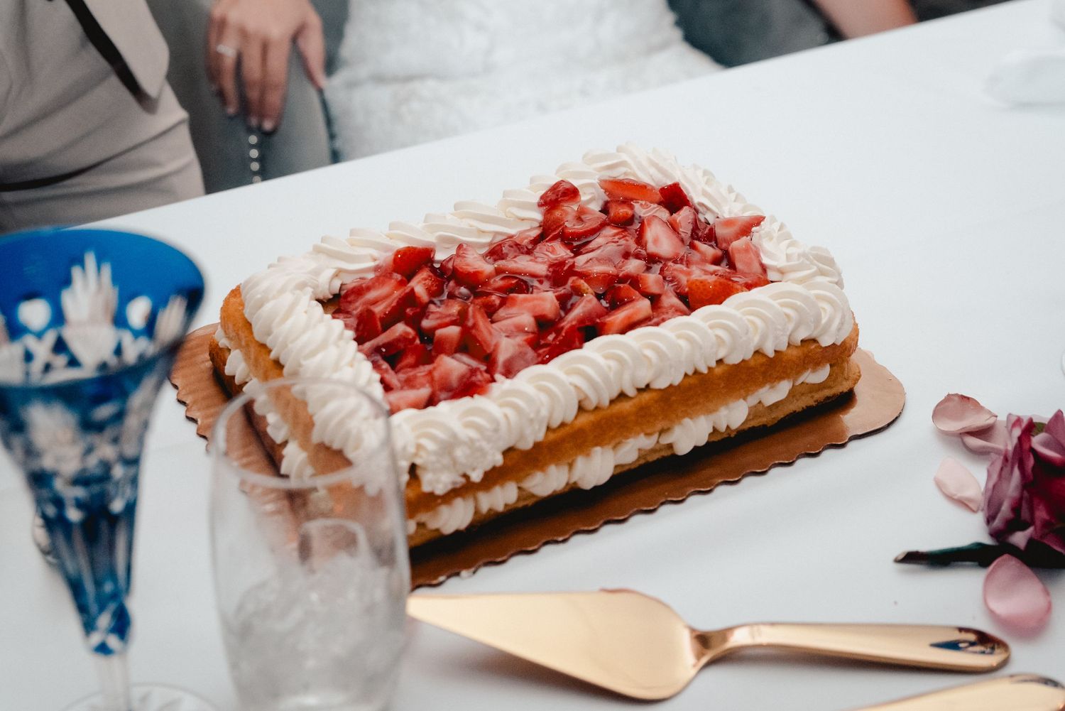 A close up of a wedding cake topped with strawberries for a wedding at the Riverdale in Endicott, NY.