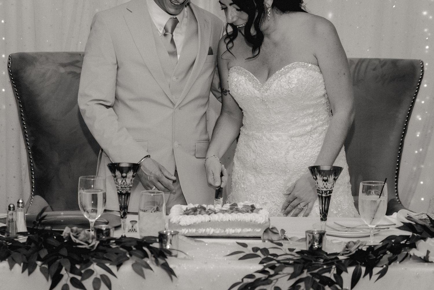 Timeless black and white photo of the bride and groom cutting their wedding cake at the Riverdale in Endicott, NY.
