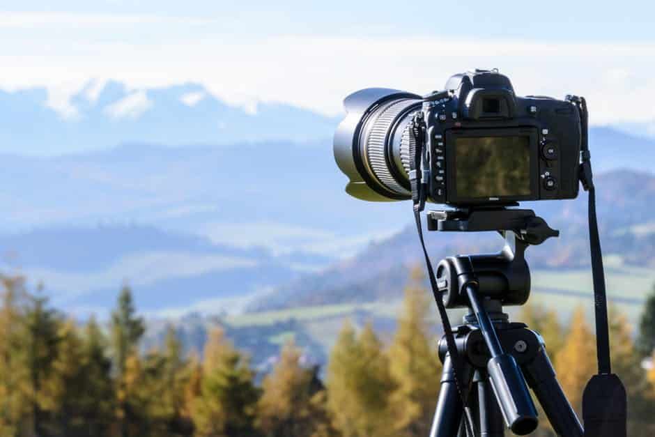Graphic of a Camera on Tripod viewing a Mountain Landscape