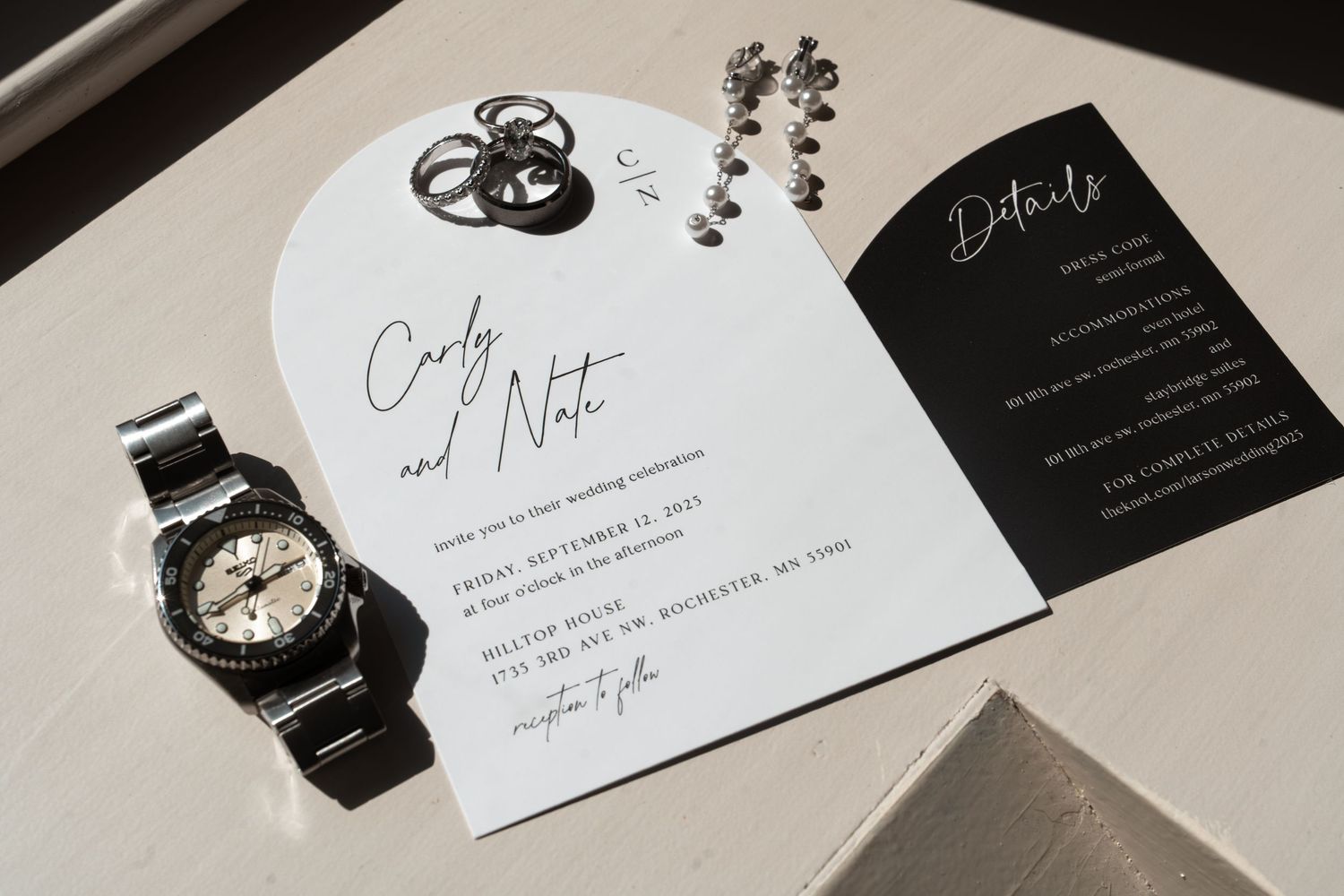 Modern wedding invitation suite featuring elegant black and white design elements.