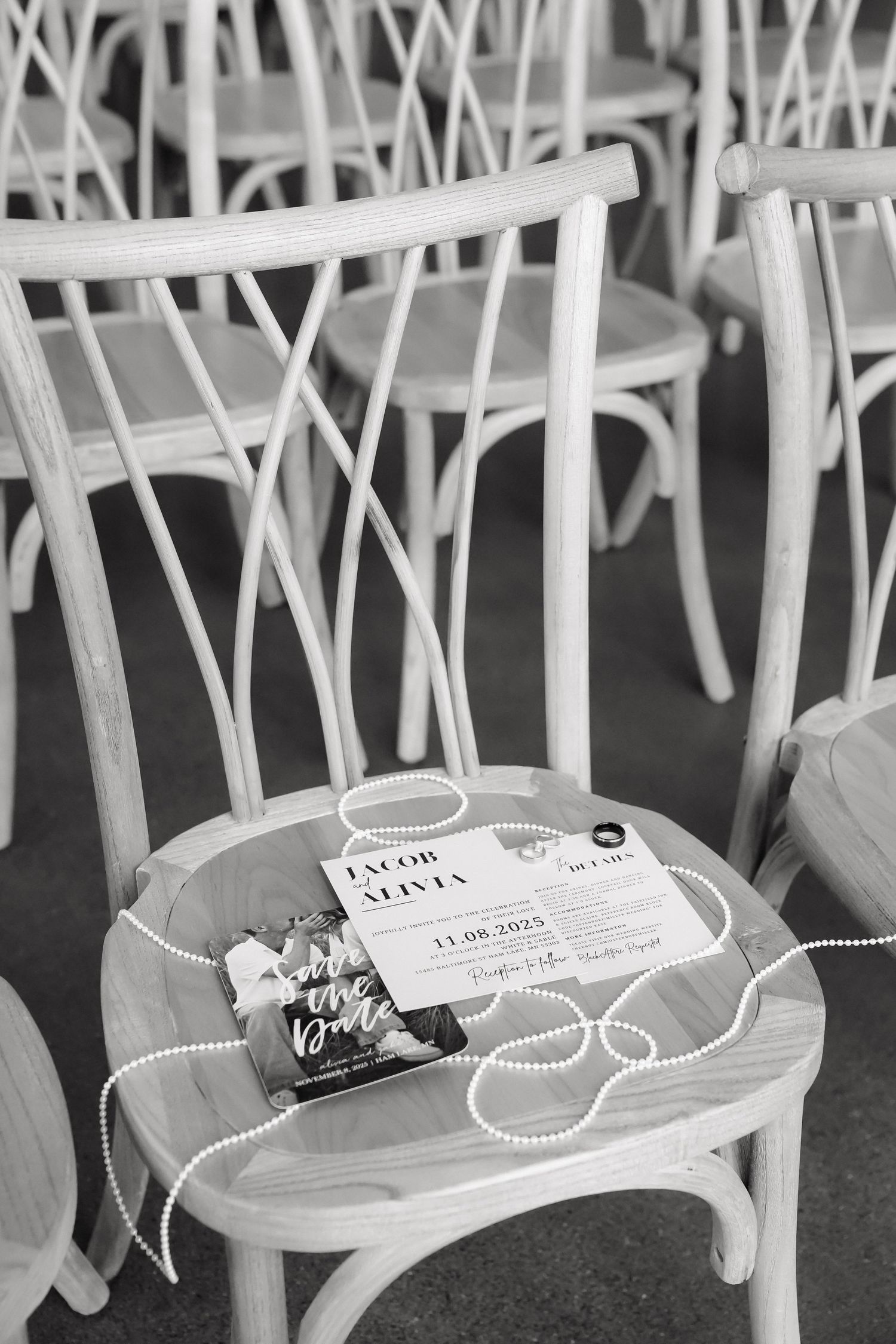 White folding chairs with signs reserved for wedding guests.