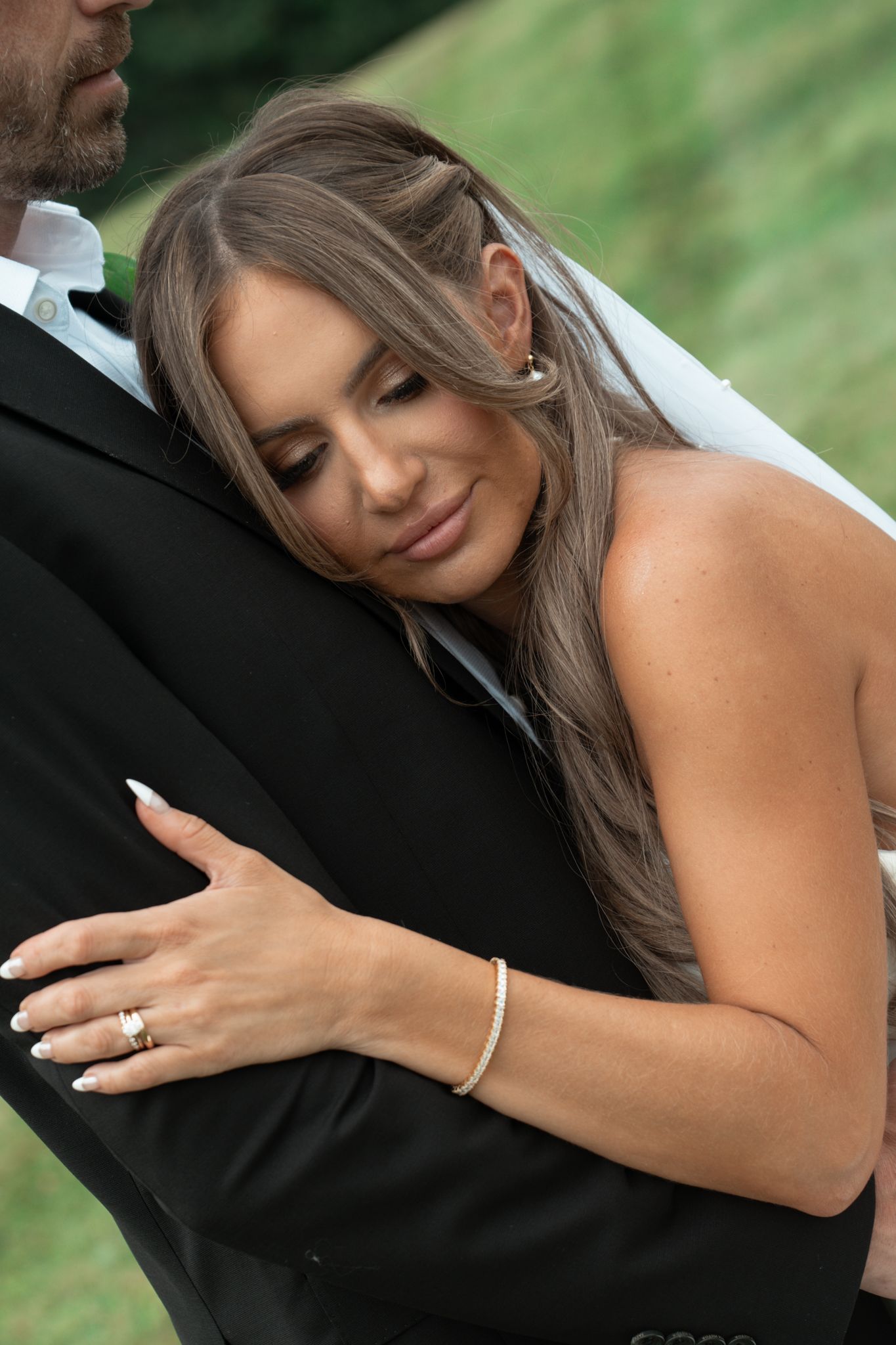 Close-up wedding photos showing bride's ring and intimate moments with groom.