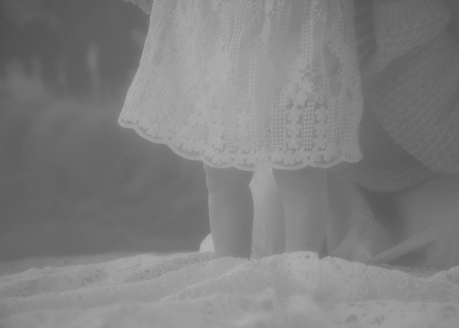 Black and white close-up details of a white lace dress.
