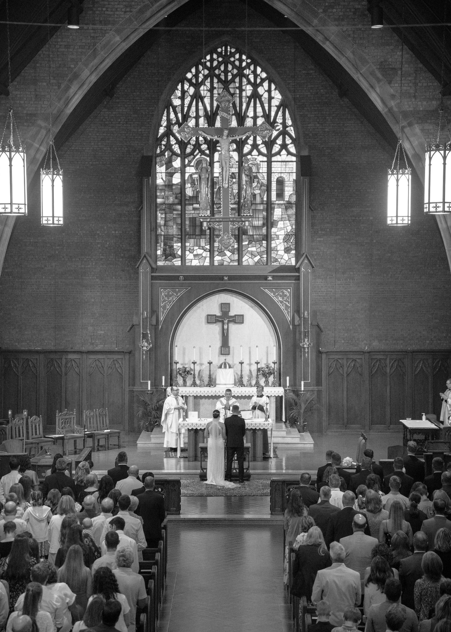 Interior of a traditional church filled with wedding guests during a ceremony.