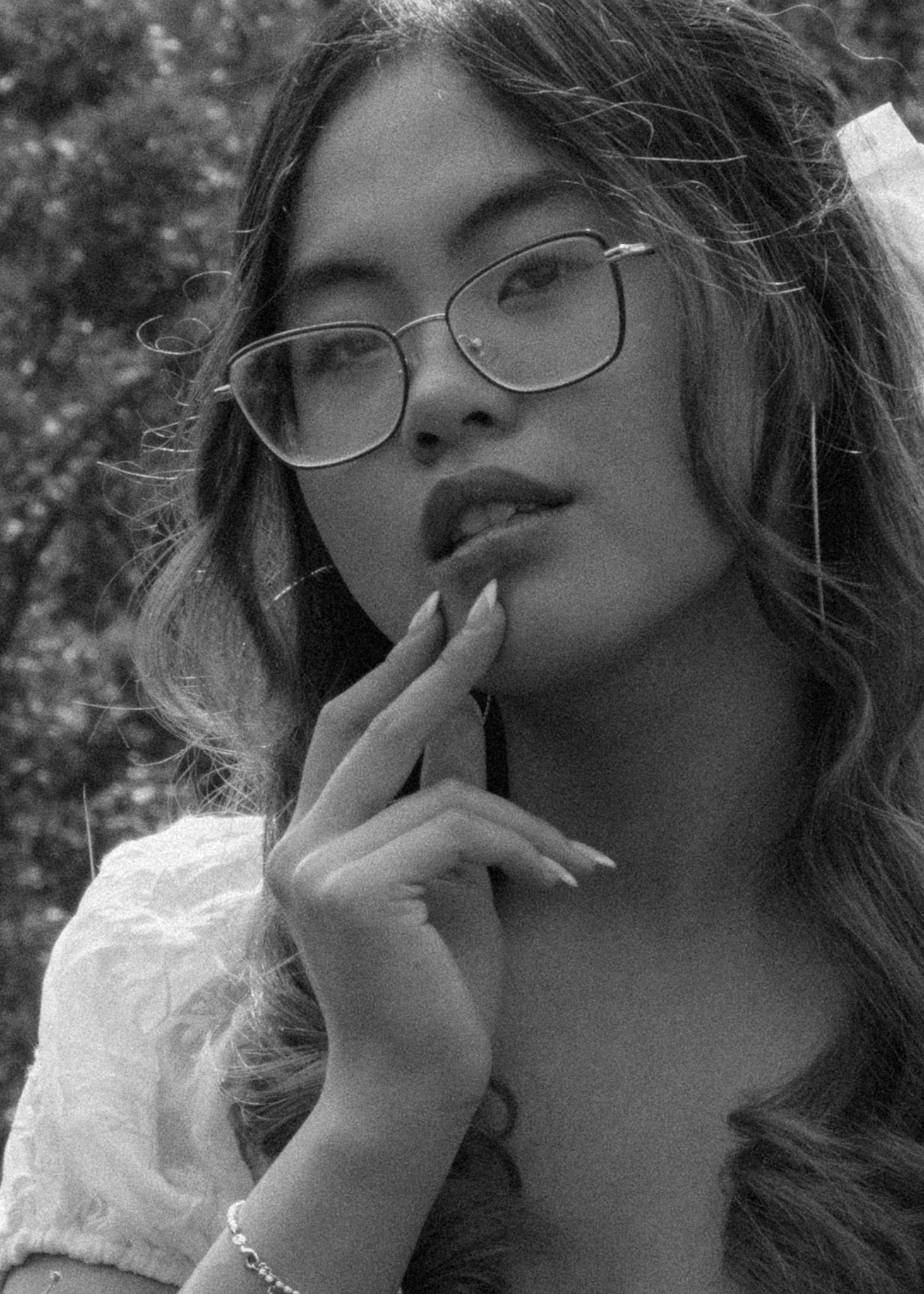 A series of black and white portraits showing contemplative poses with glasses.