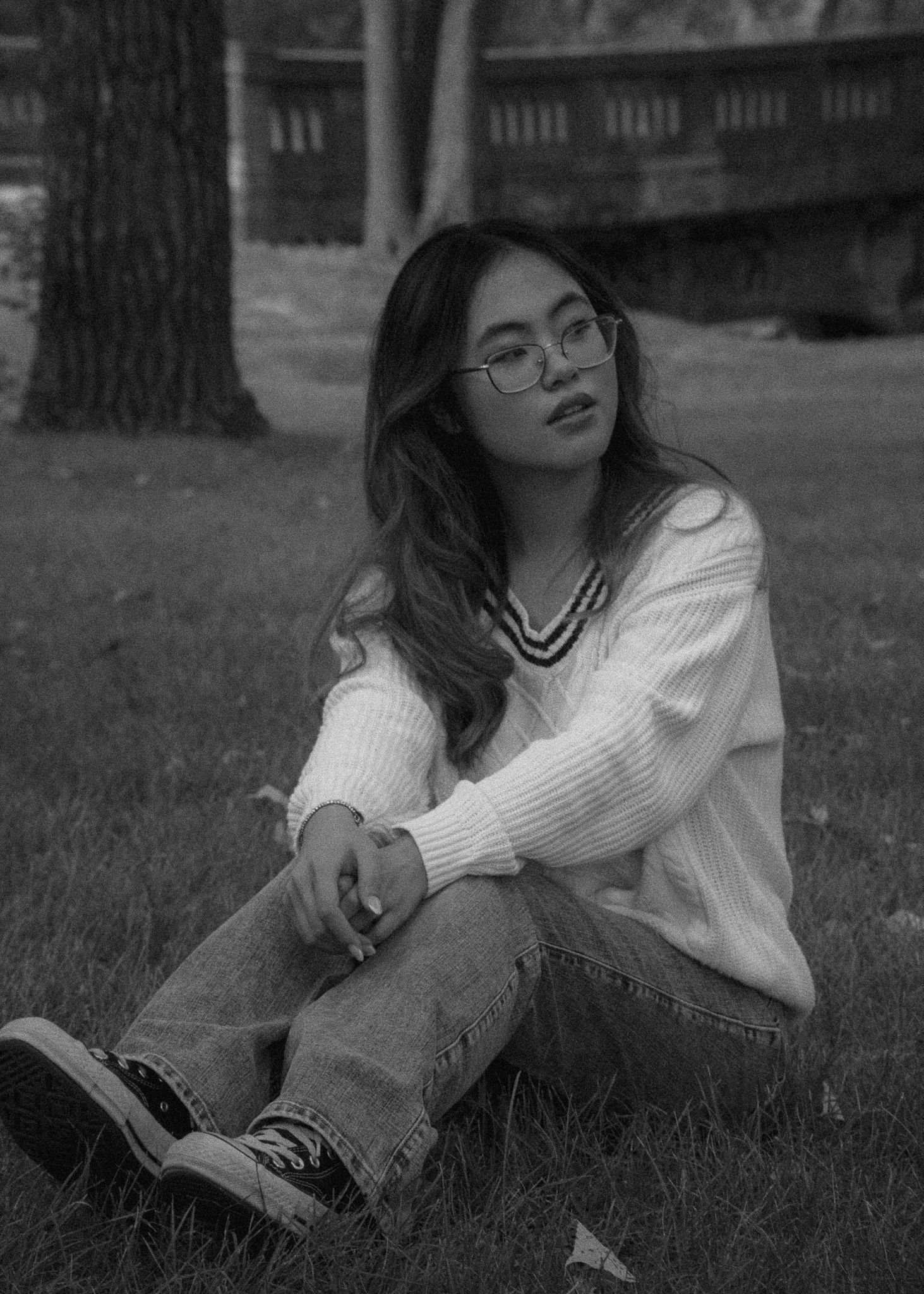 Black and white portraits on grass showing relaxed poses in casual attire.