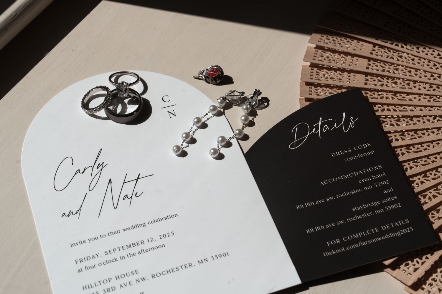 Elegant black and white wedding invitation suite with floral accents and modern calligraphy on textured paper. Wedding stationary, details.