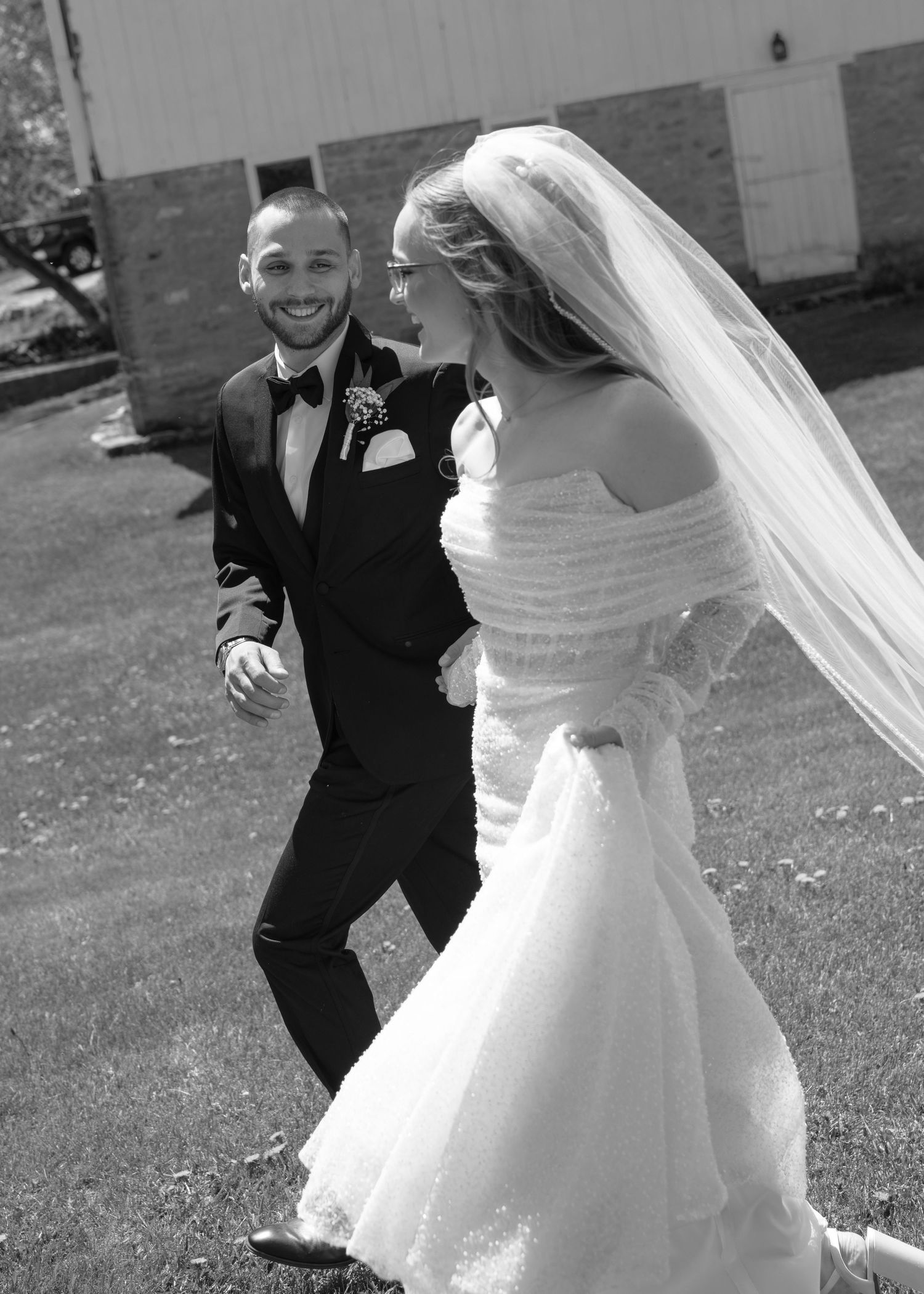 Playful black and white wedding dance sequence outdoors.