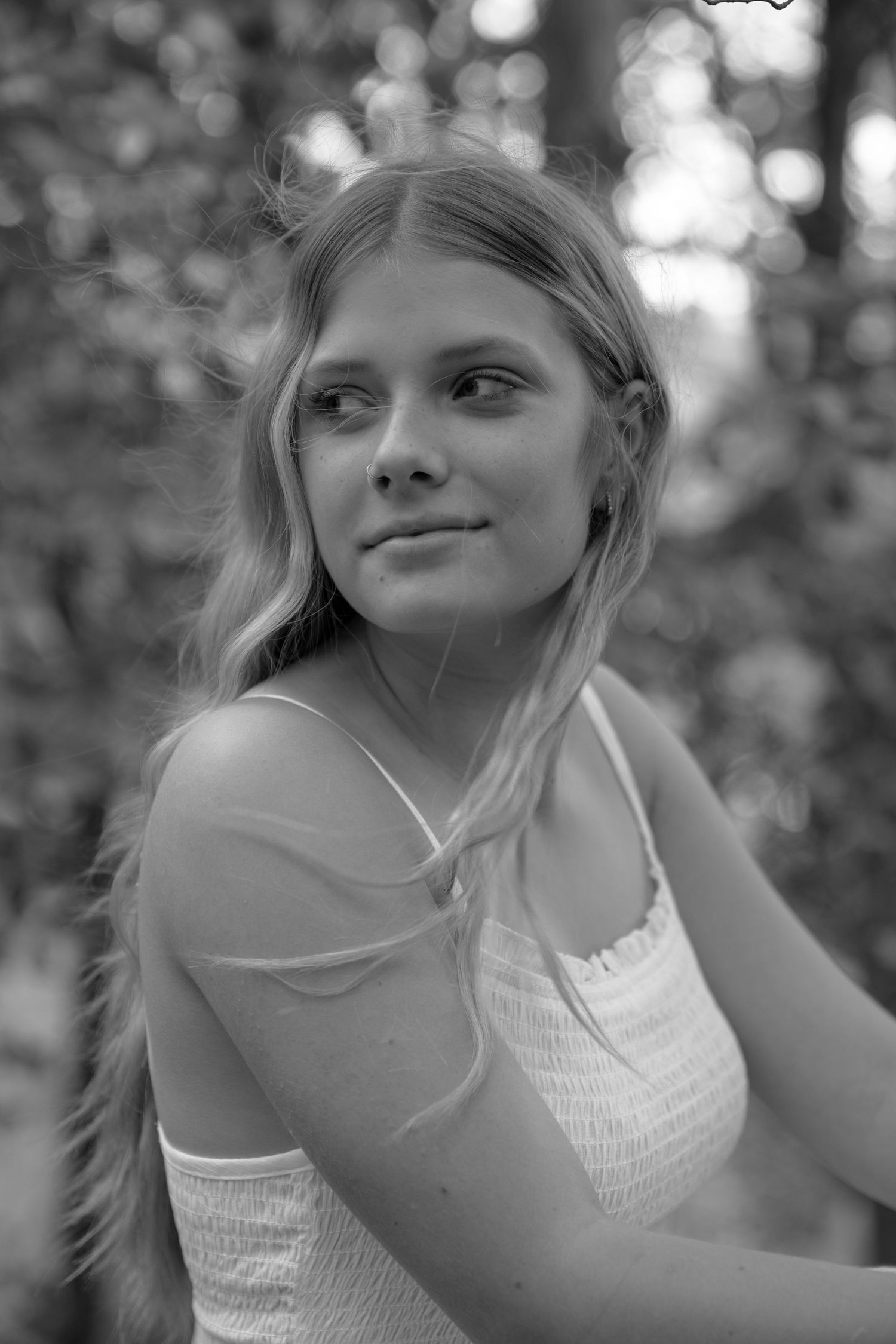 Artistic black and white photo sequence showing a person in a white top with natural lighting.