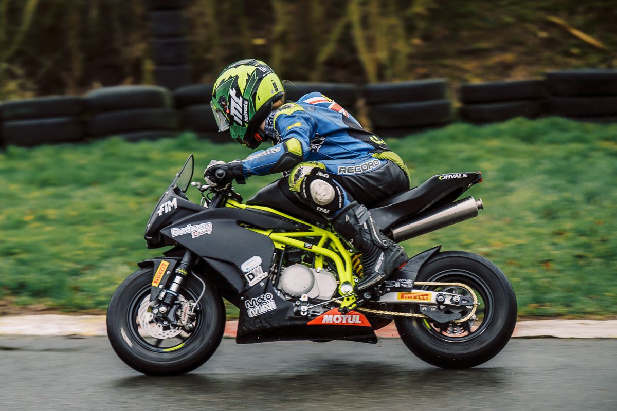Motorcycle racers leaning into turns on a racing circuit.