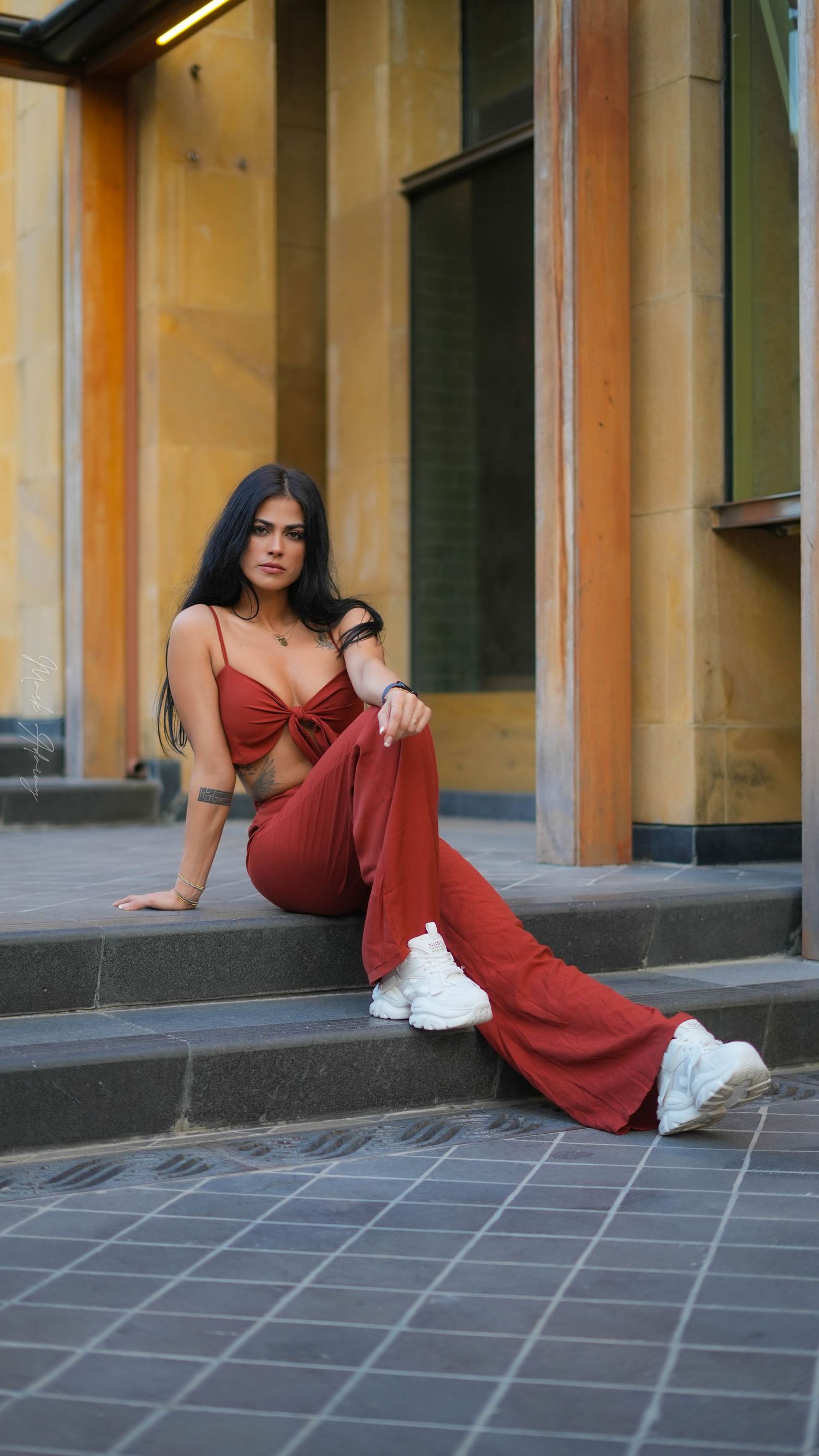 Lebanese young female model portraying in orange jumpsuit in Beirut Souks Downtown