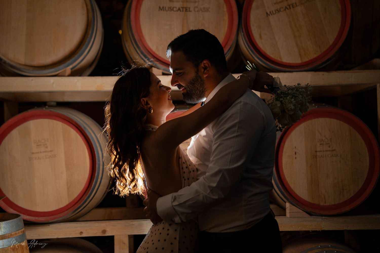 Cinematic Lebanese couple enjoying joyful pre‑wedding moment at Riachi Winery and Distillery