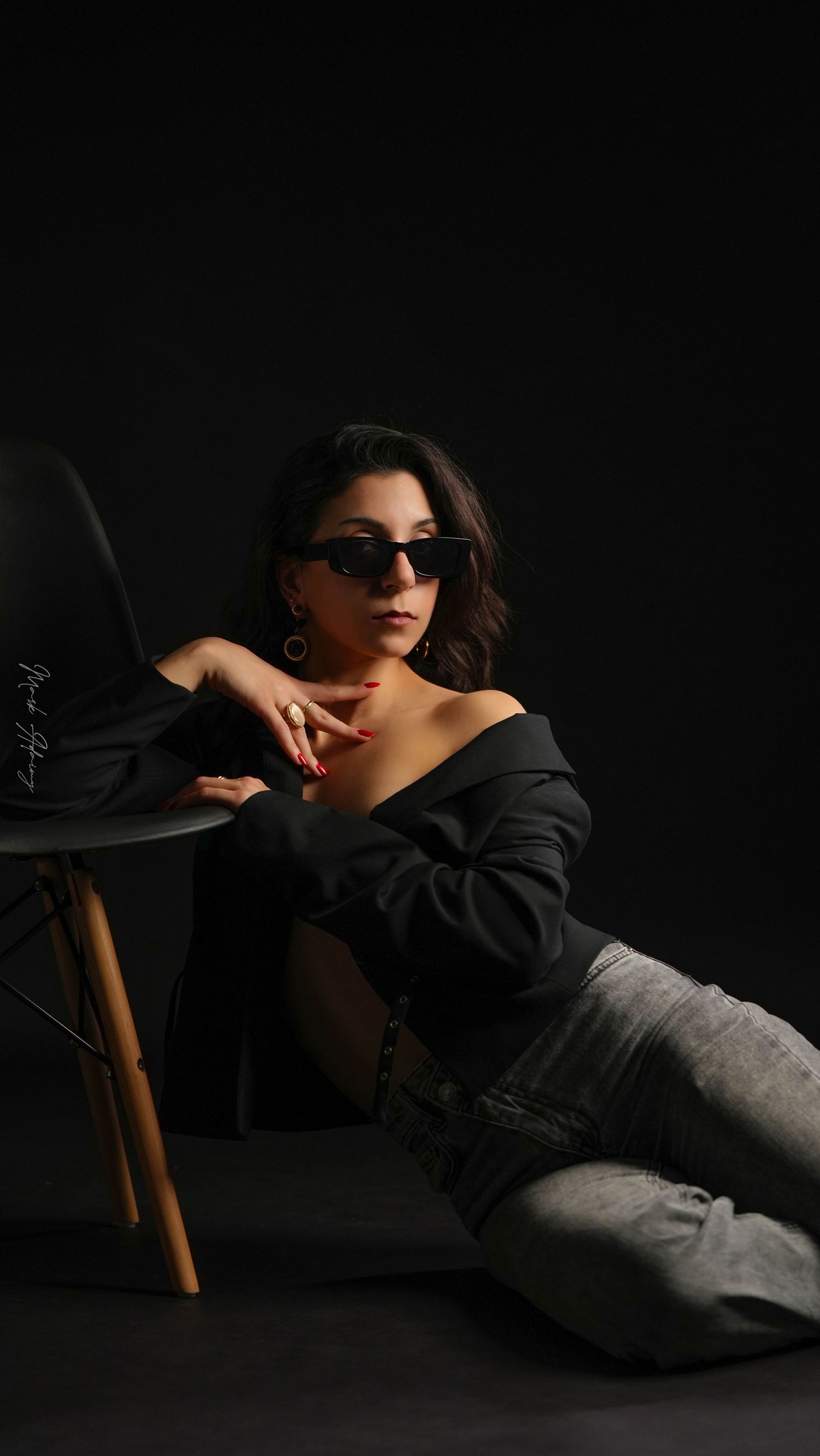 Lebanese young model in a black on black photoshoot with a chair at CMA Productions Beirut
