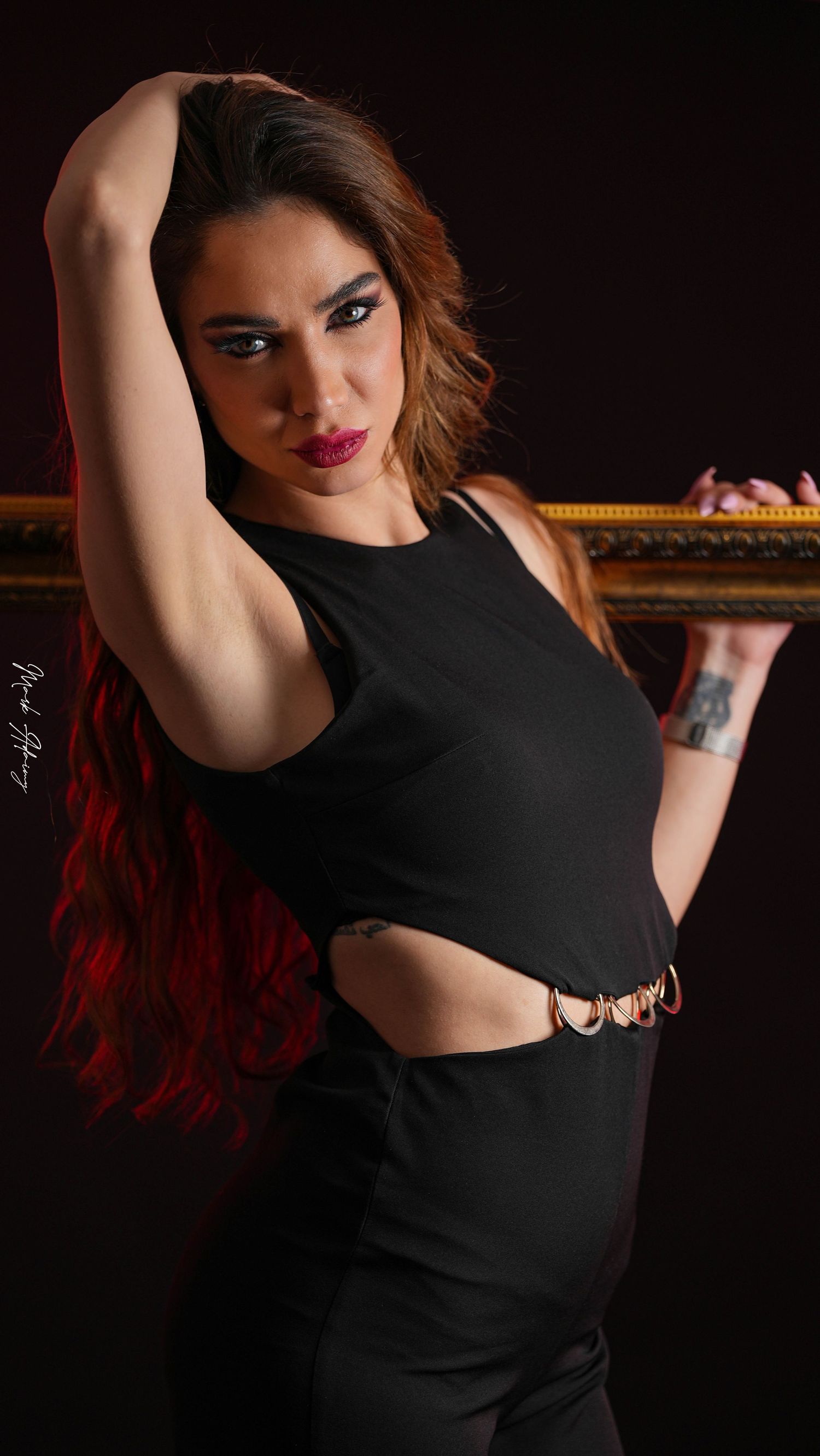 Lebanese model posing in a studio photoshoot with controlled lighting and black background at CMA Productions Beirut