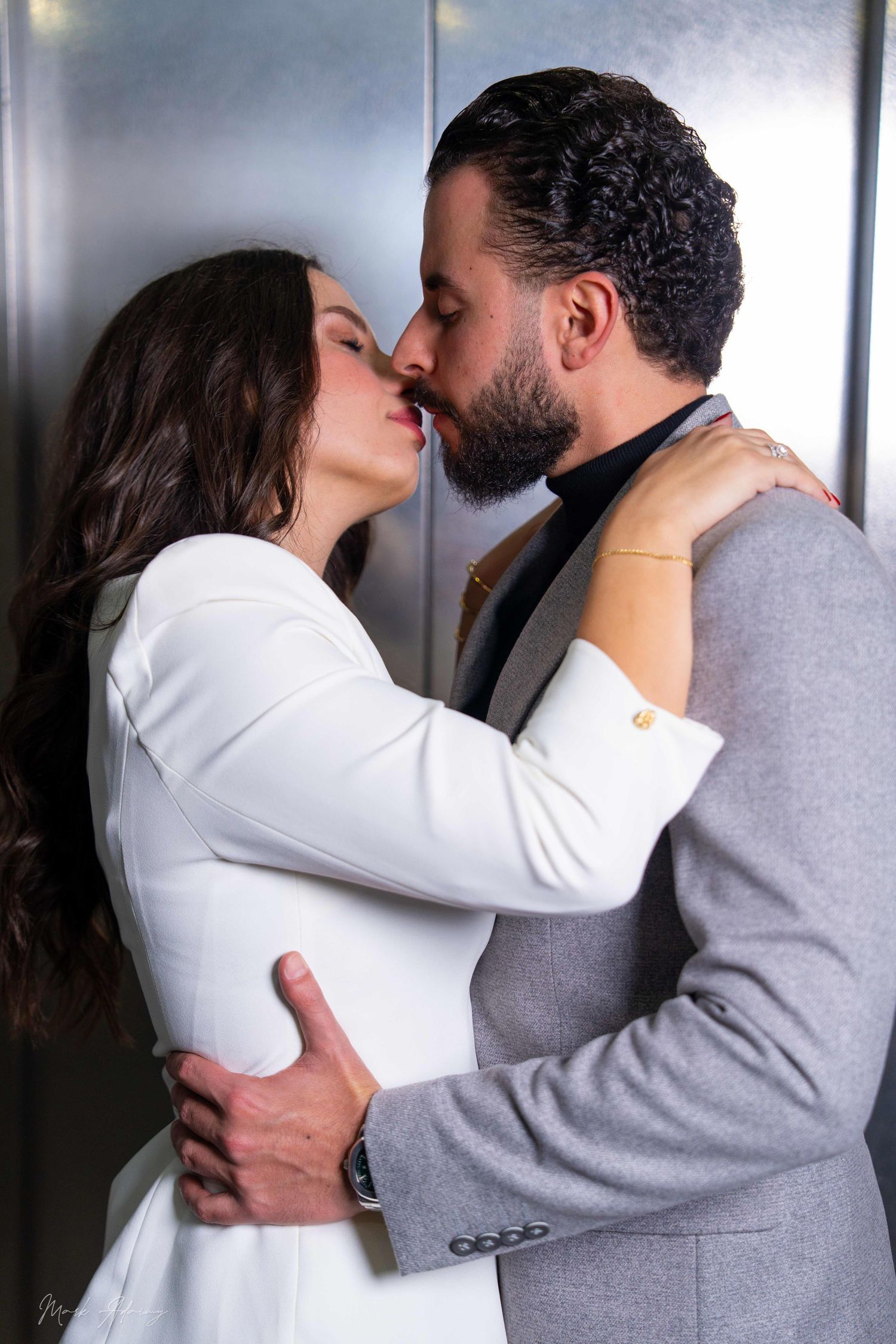 Lebanese couple kissing each other in their pre-wedding photoshoot at Queens Plaza Beirut