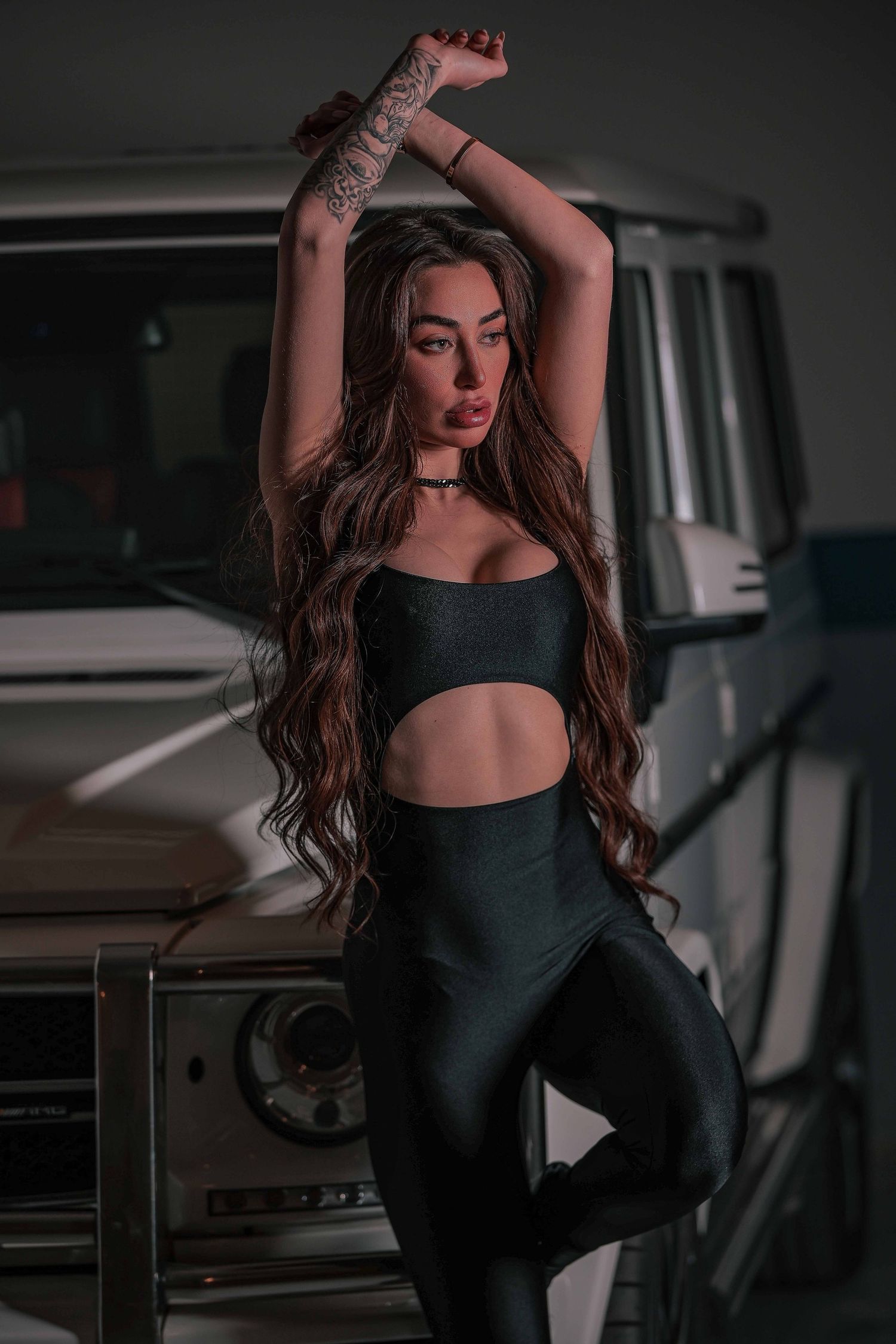 Lebanese model striking a confident pose in front of her G-class in Beirut