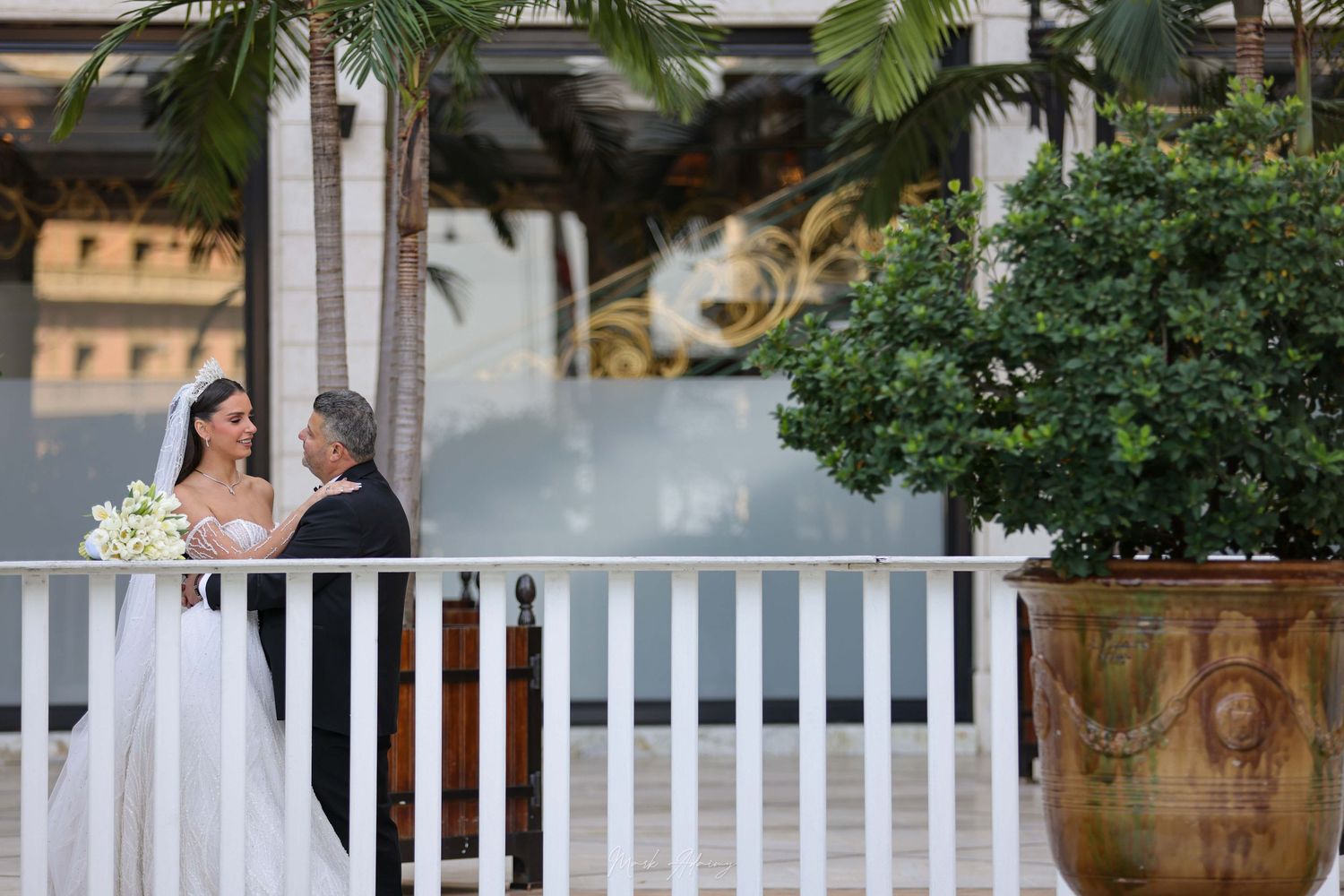 Lebanese wedding couple walking hand in hand at Phoenicia Hotel Beirut garden