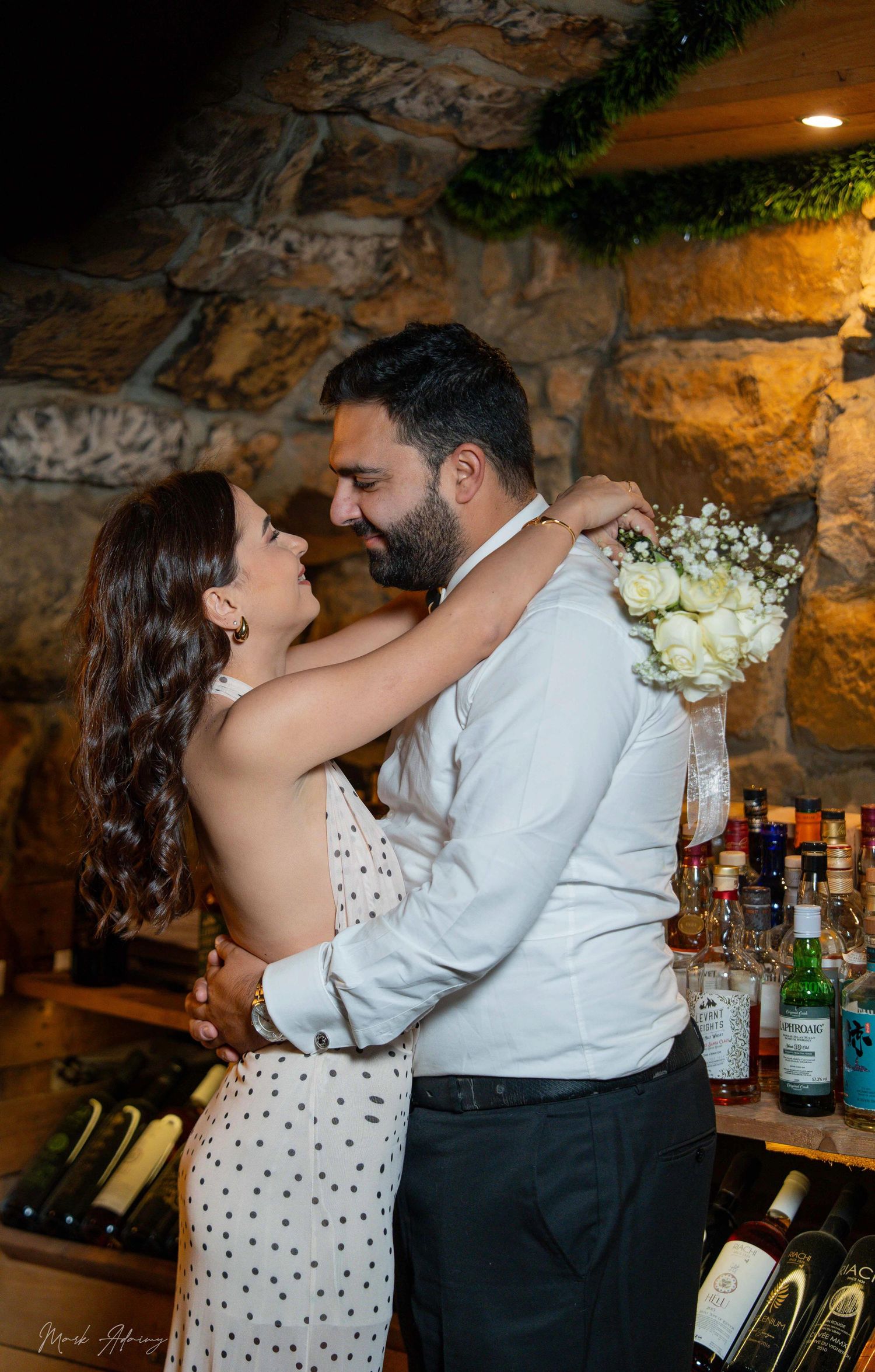 Romantic Lebanese couple portrait with candid laughter at Riachi Winery and Distillery