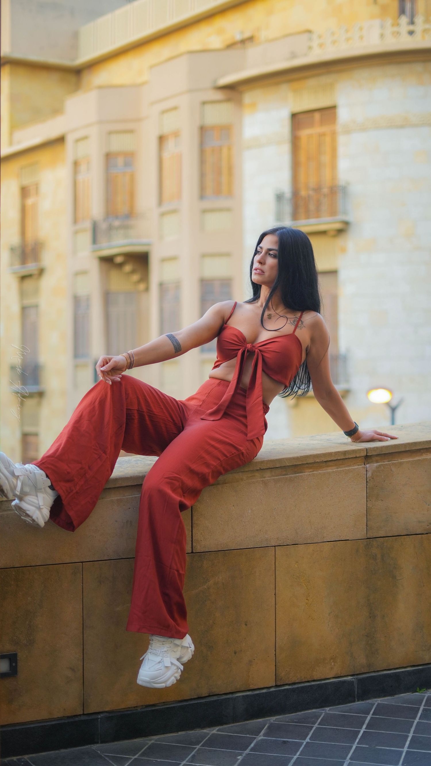 Wide shot for a Lebanese young female model in orange jumpsuit in Beirut Souks Downtown