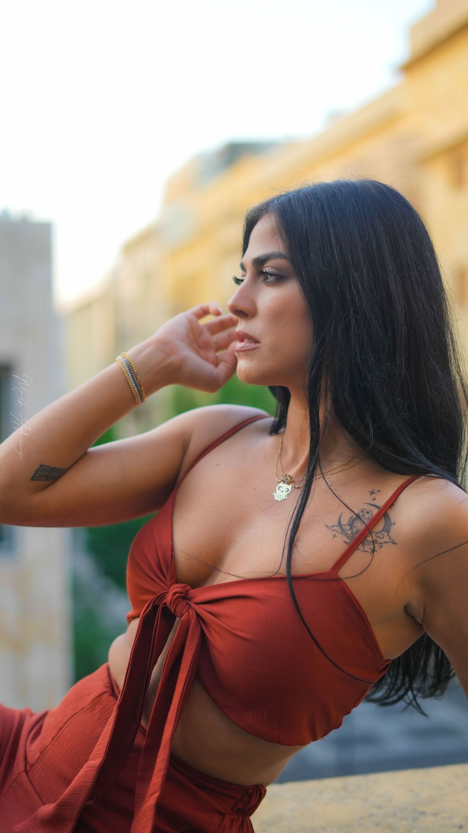 Close up for a Lebanese young female model in orange jumpsuit in Beirut Souks Downtown