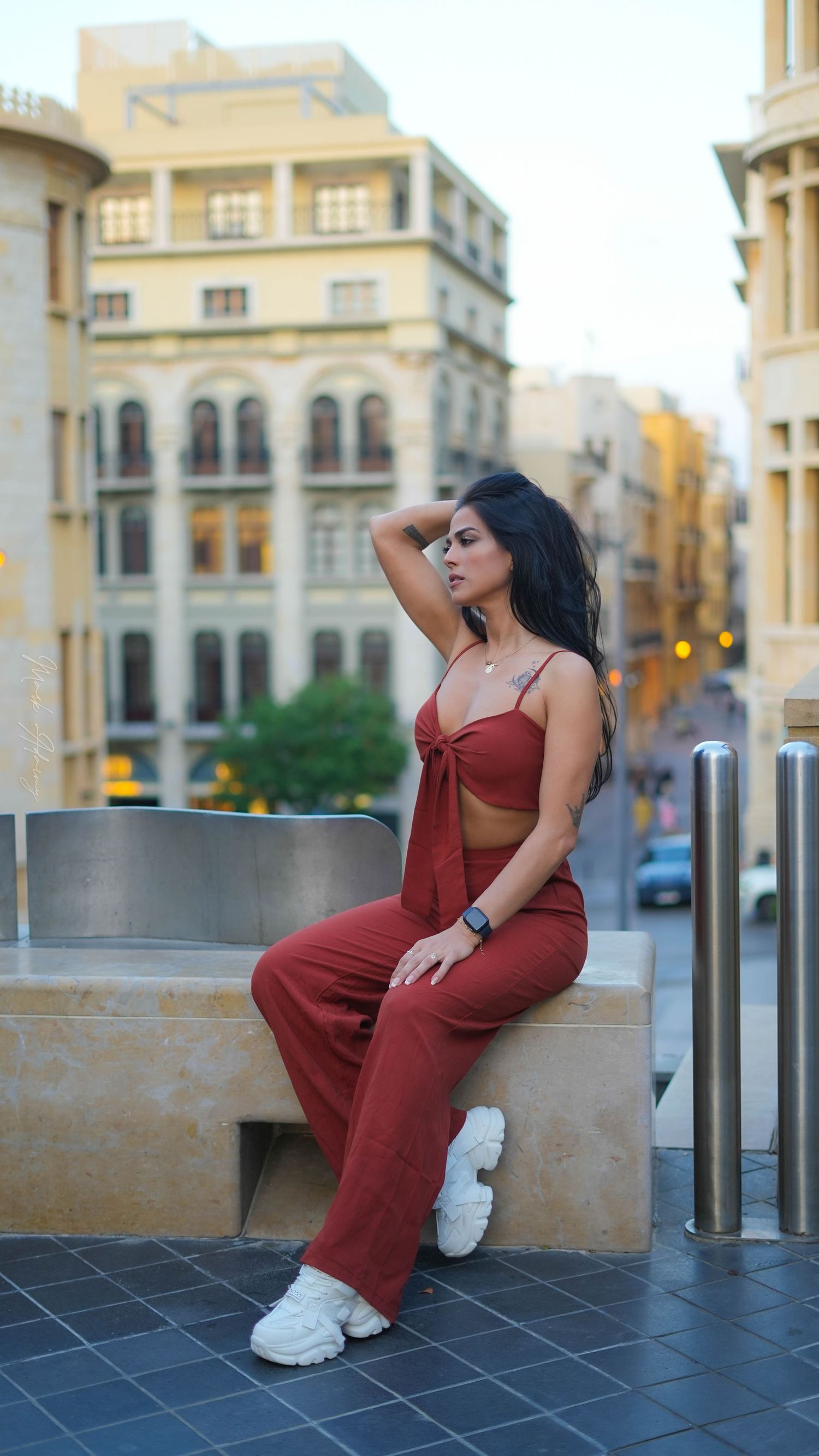 Lebanese young female model in orange jumpsuit in Beirut Souks Downtown