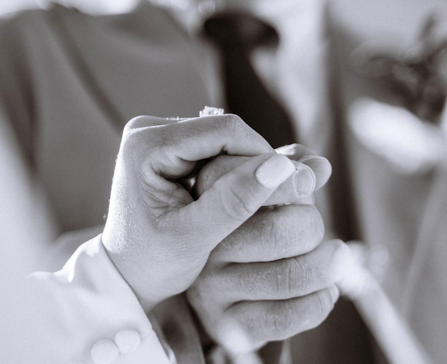Close up of couple holding hands during LDS wedding ceremony in London