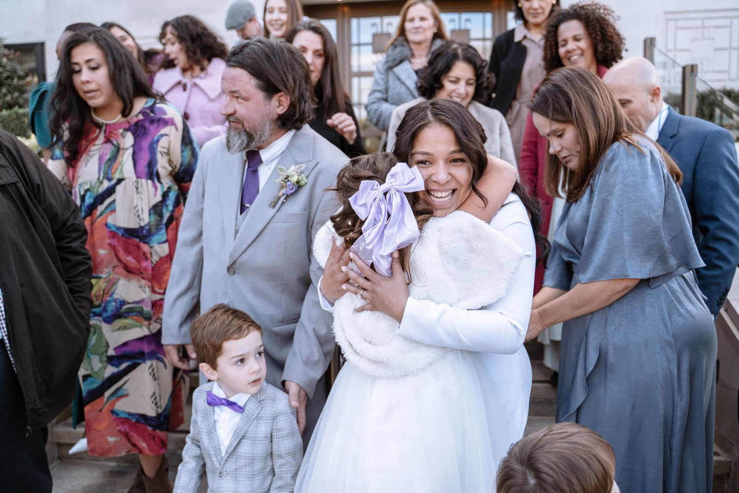 Guests hugging together after LDS wedding ceremony in London