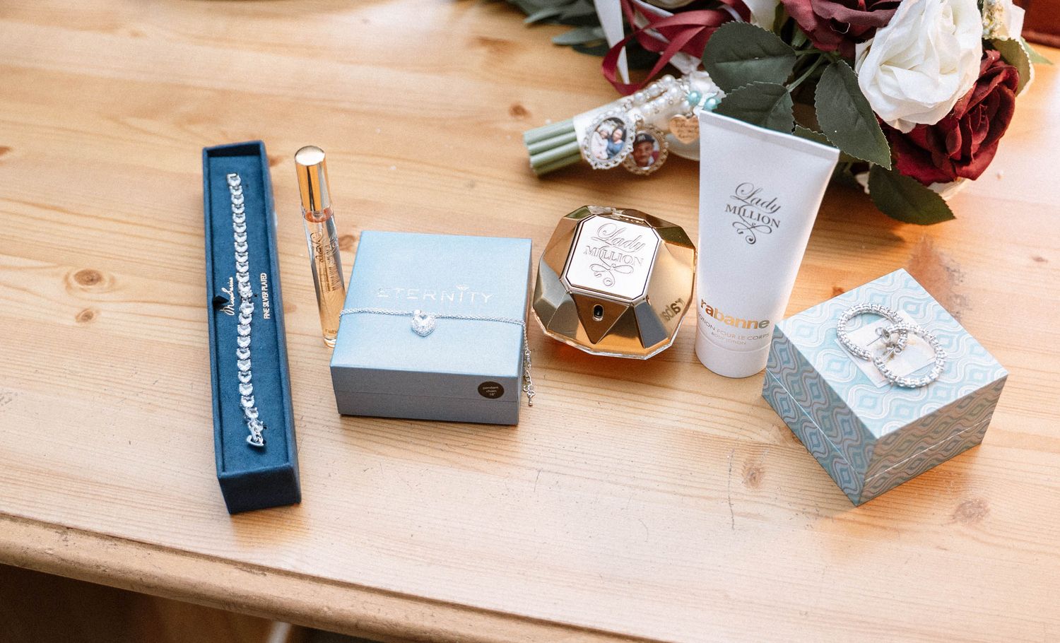 Birmingham Jamaican church wedding details flat lay rings perfume jewellery and accessories on wooden table