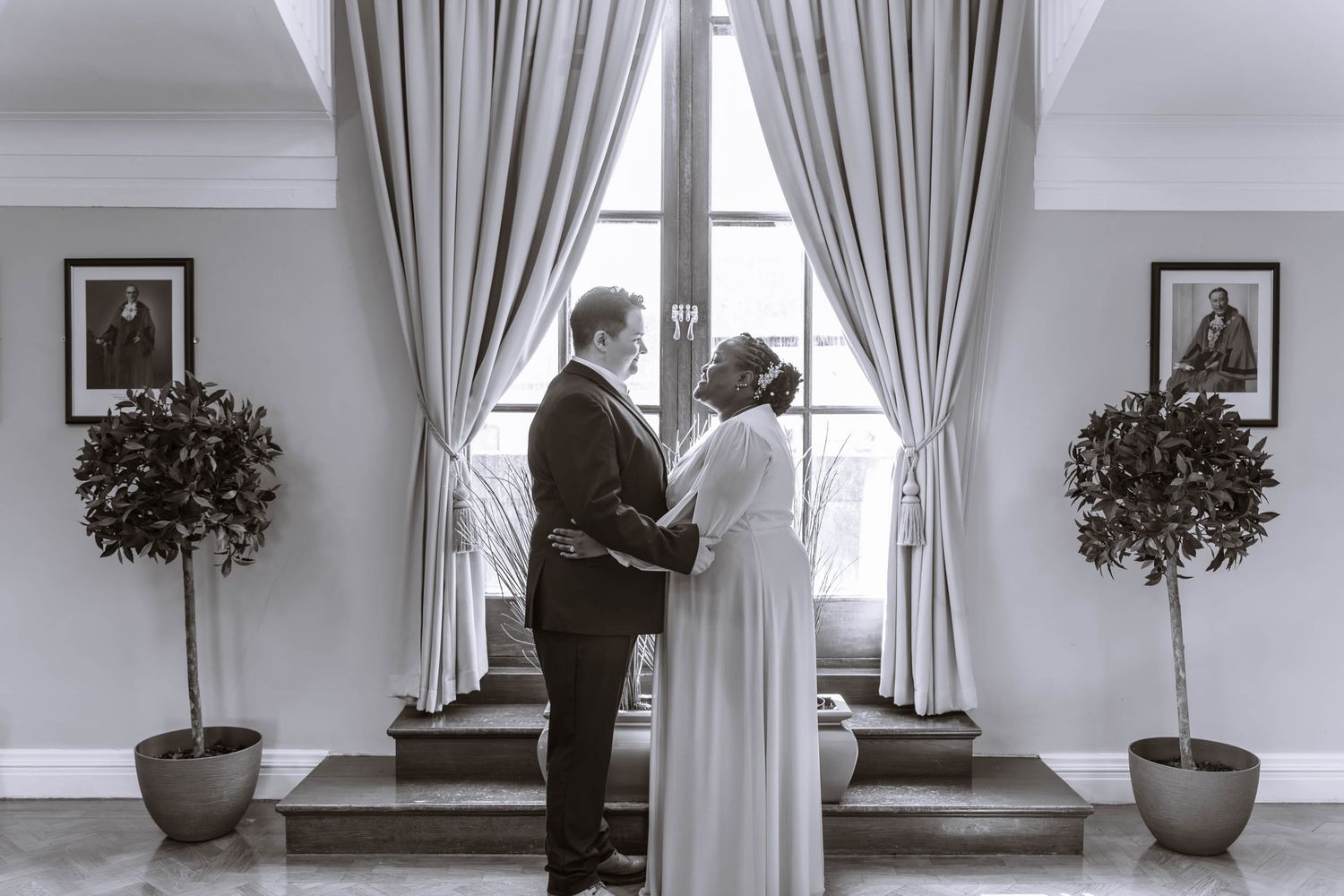 Couple standing together in front of window during registry wedding ceremony