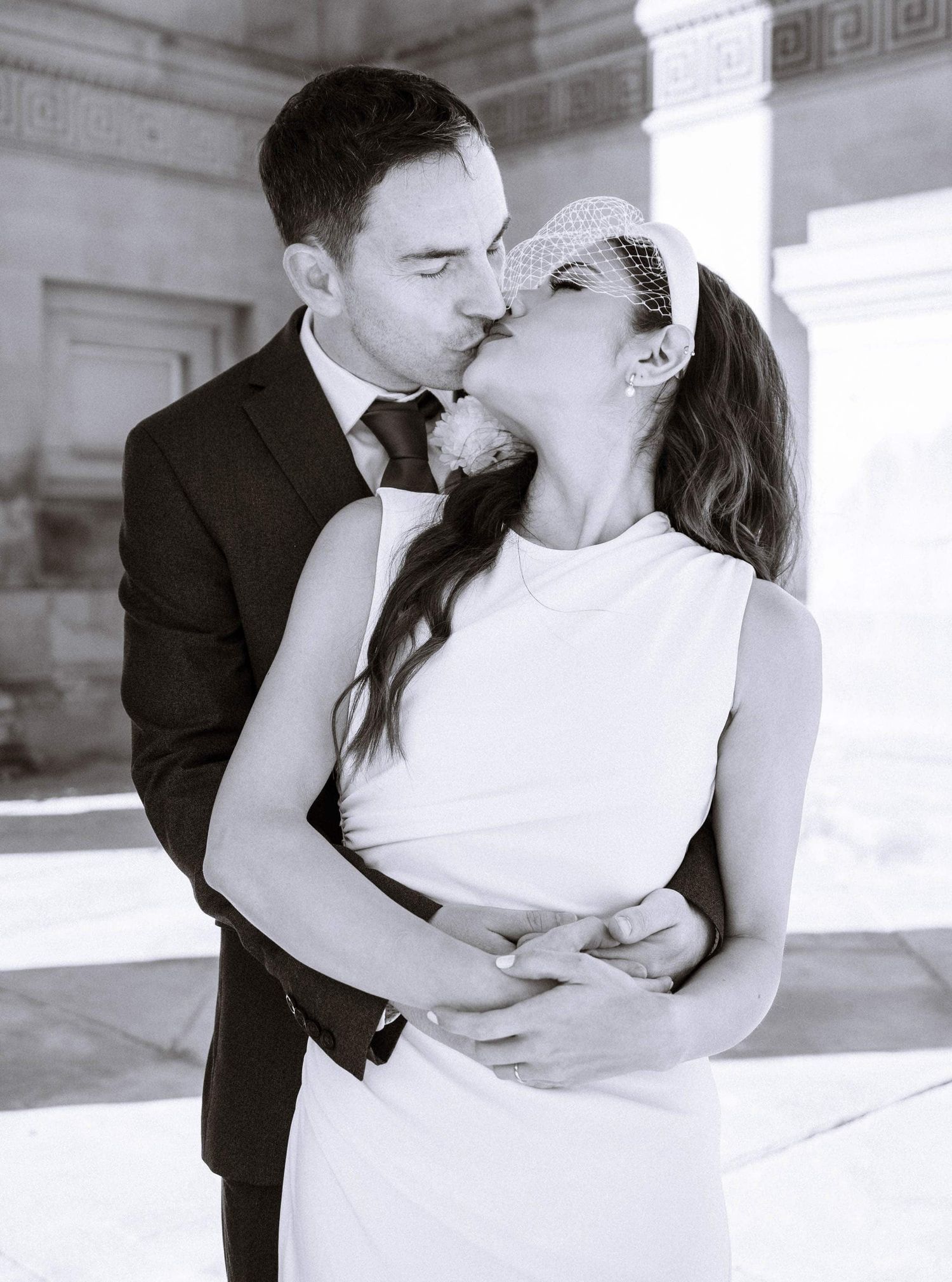 Bride and groom kissing outside the entrance hall of Liverpool St George Hall.