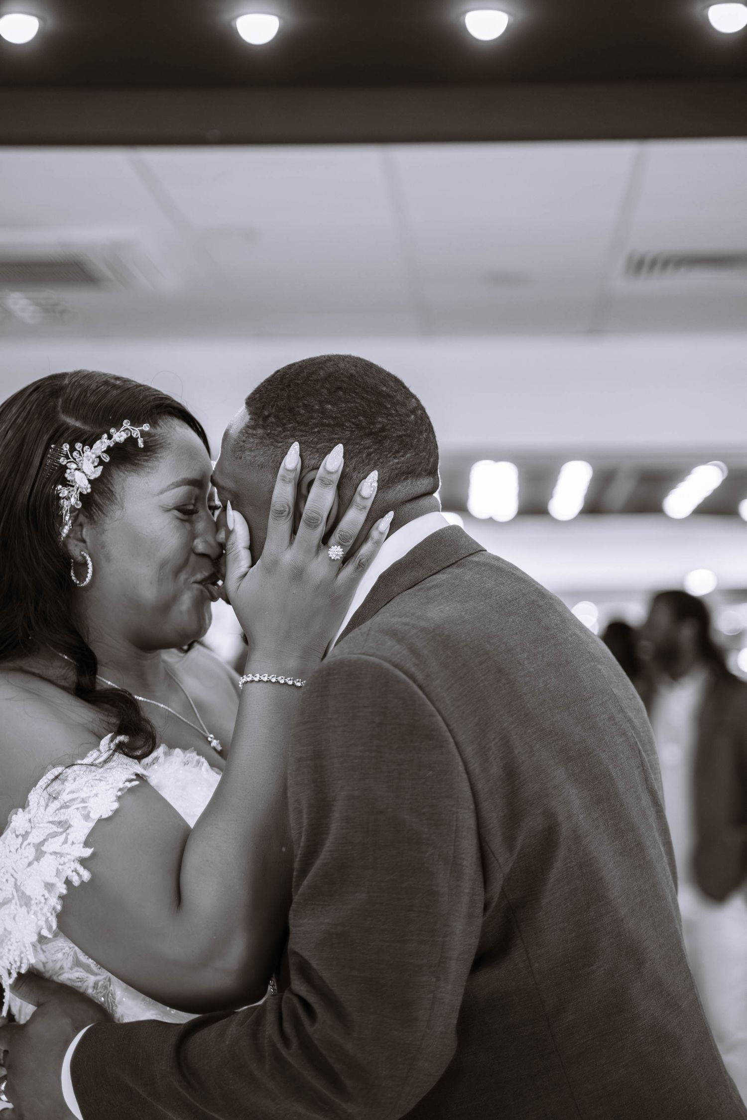 A romantic black and white wedding kiss sequence showing a couple's first kiss as newlyweds.