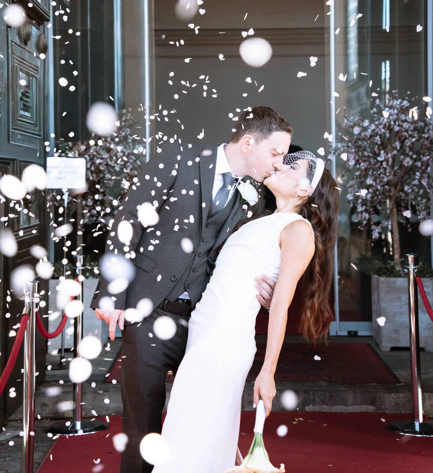 Confetti moment outside Liverpool St George Hall after a civil wedding ceremony.