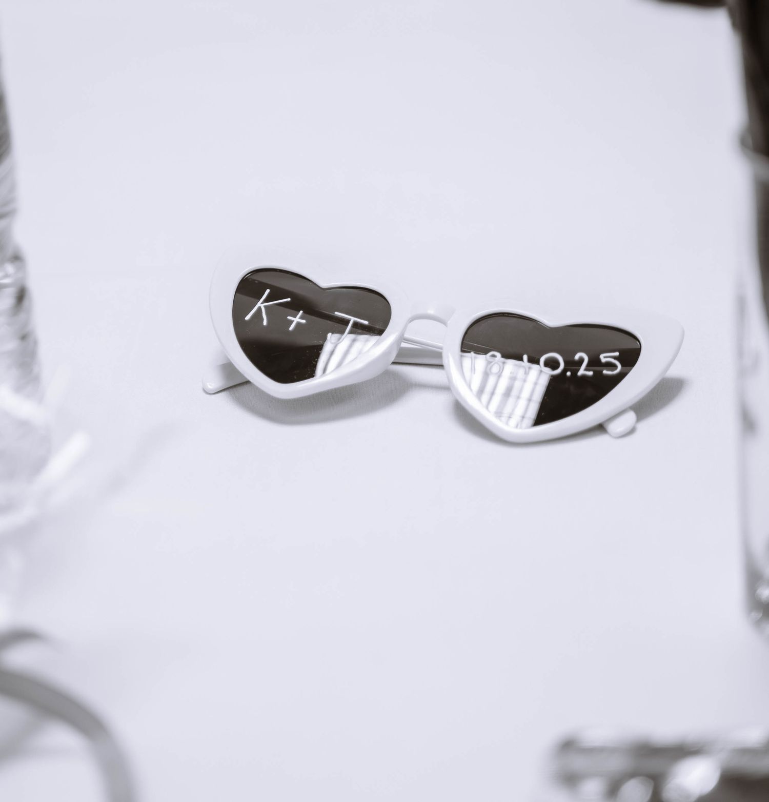 Wedding detail of personalised sunglasses on table during Jamaican wedding reception in Birmingham