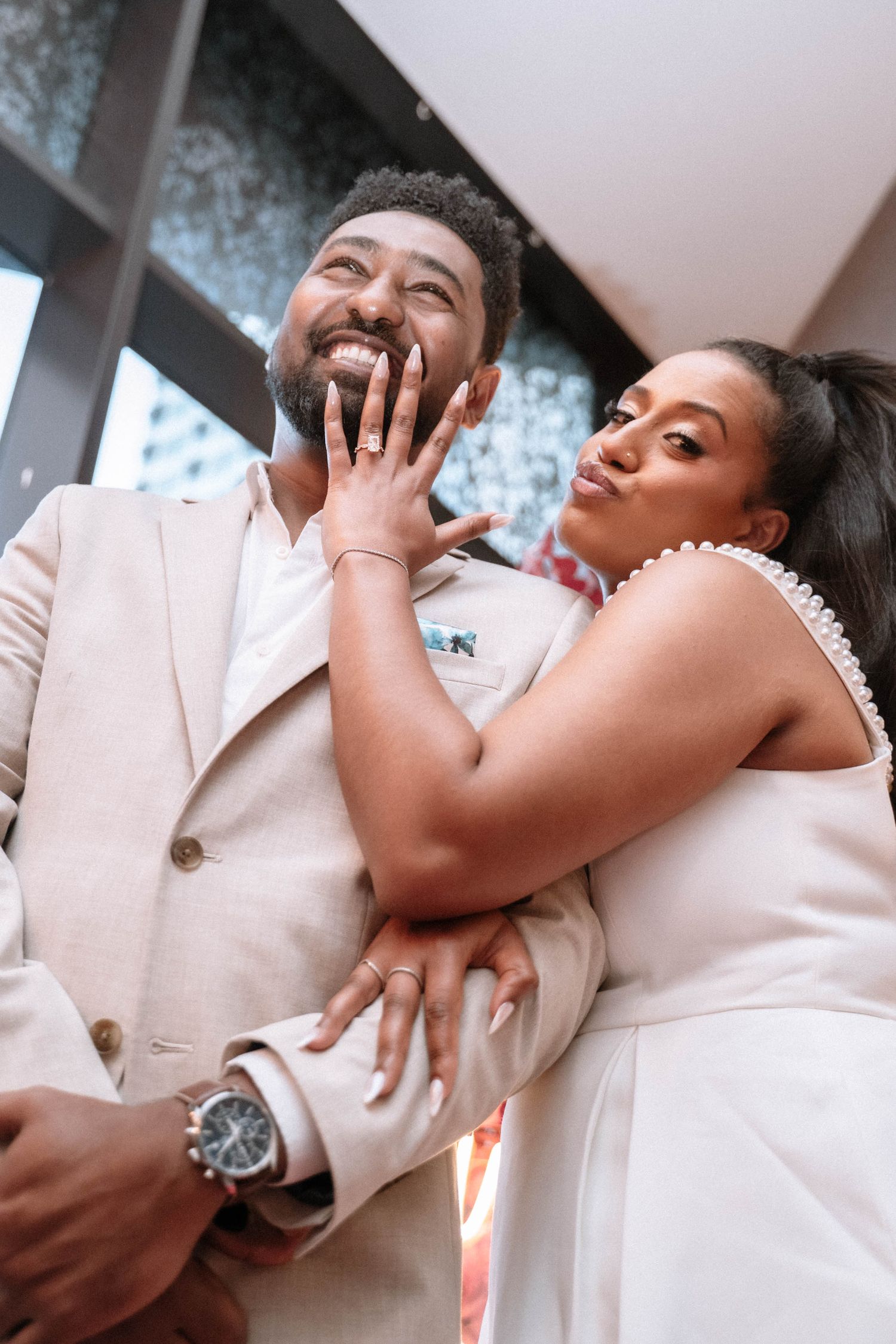 Black couple smiling together after their Manchester proposal