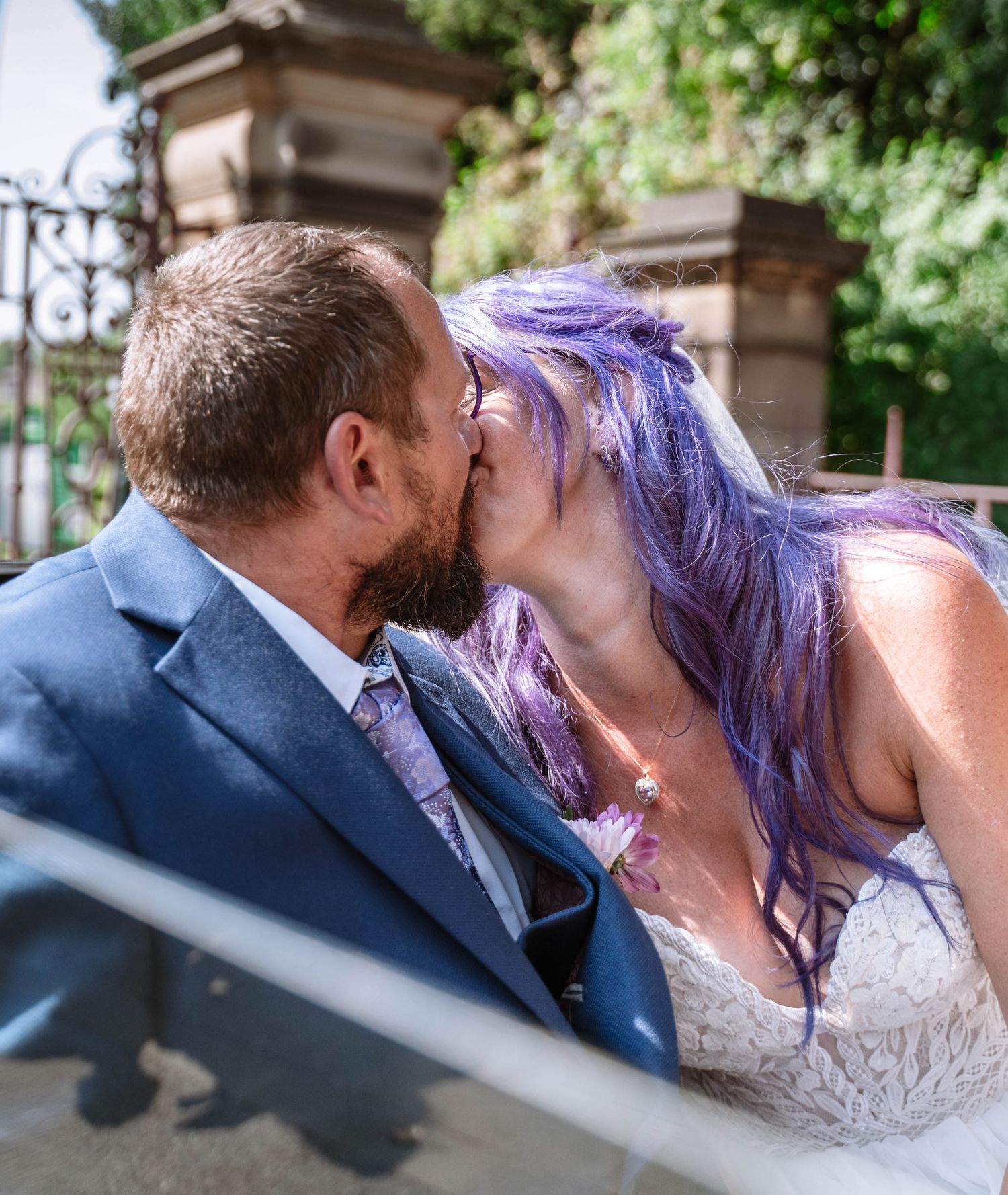 Newlywed couple kissing outdoors after their Wigan registry office ceremony