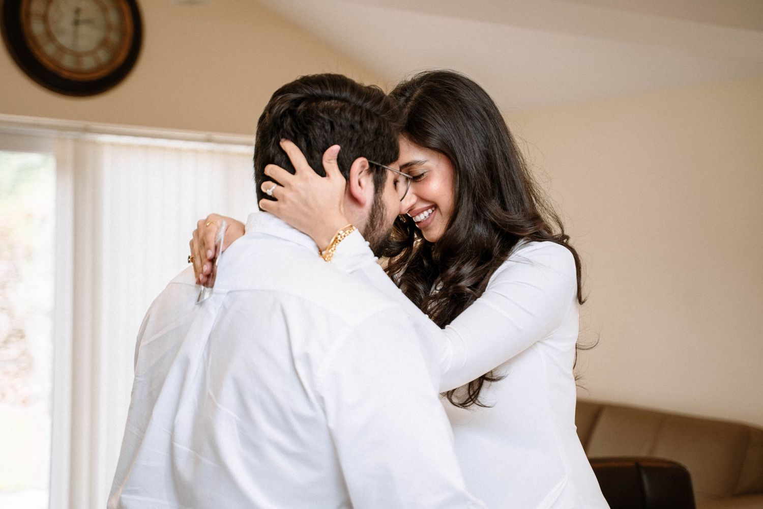 Pregnant woman laughing with her partner in the dining room during a Manchester maternity session