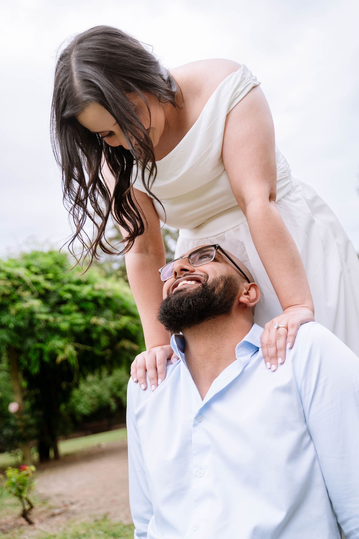 Couple sharing a playful moment outdoors during their Manchester proposal photography session
