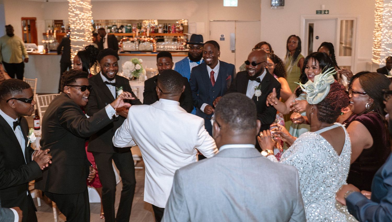Guests dancing in a circle during Ravens Ait wedding reception in London