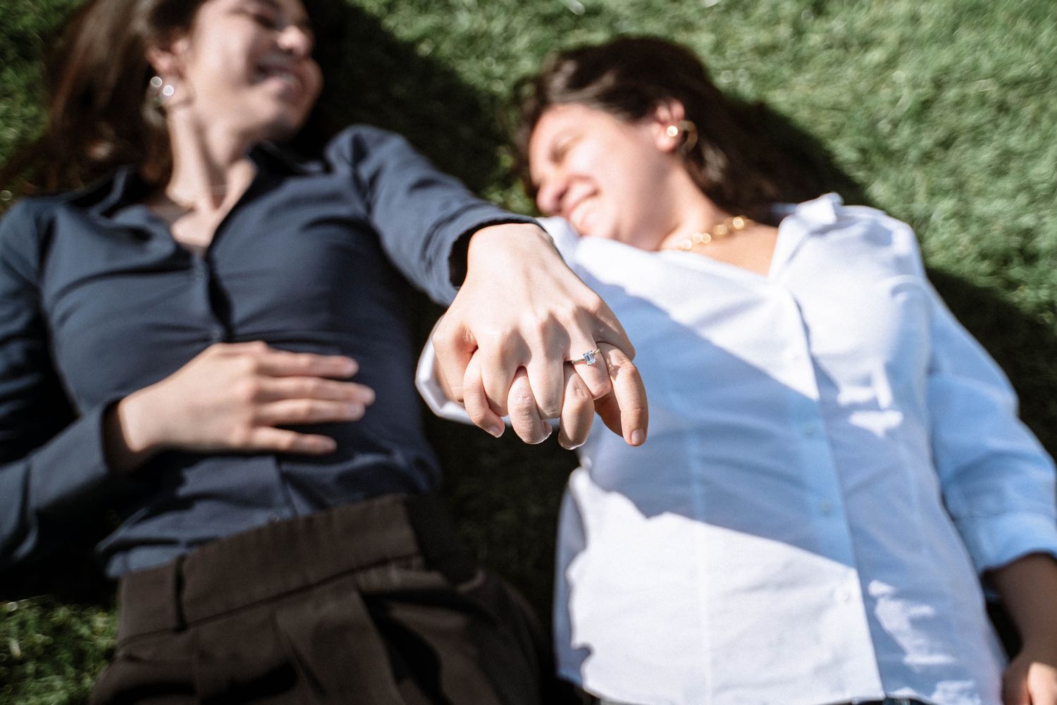 Queer couple in Cardiff holding hands out towards the camera