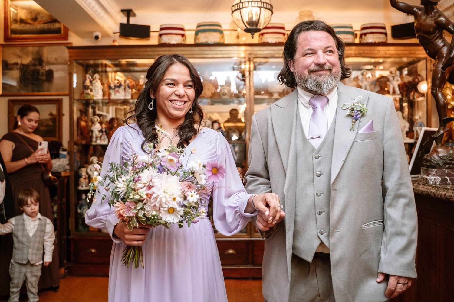 Bride walking with groom inside Trafalgar Tavern wedding reception