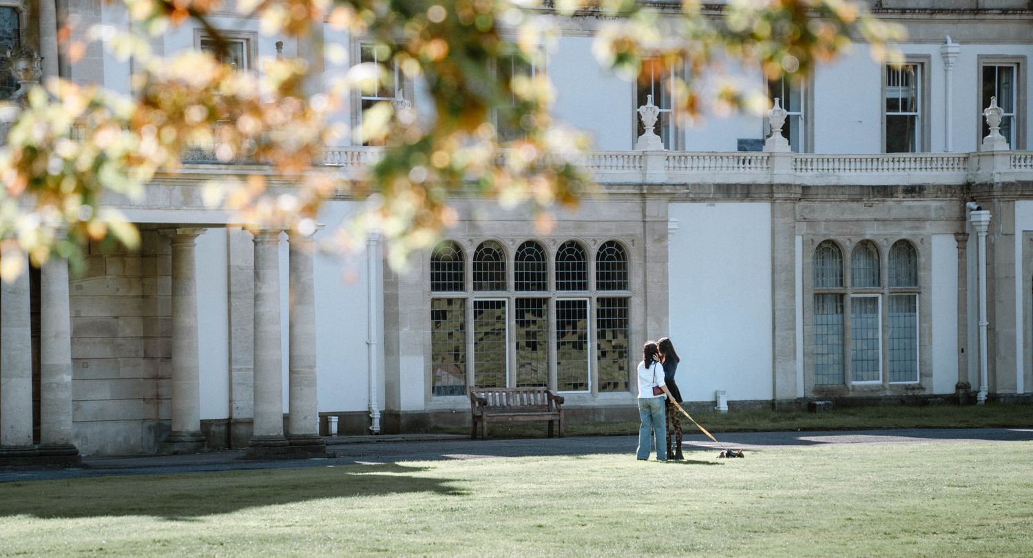 Couple standing outside large venue during Cardiff proposal photography