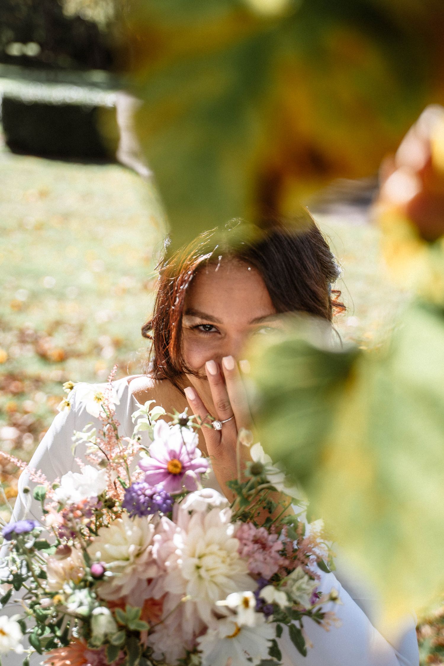 Mormon LDS wedding bride portrait London temple gardens autumn bouquet smiling through leaves wedding photography London